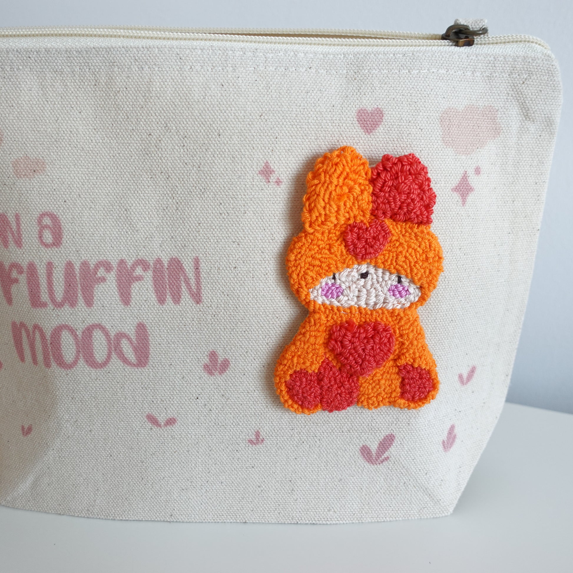 Fluff Club craft pouch filled with crafting supplies, demonstrating its functionality and design.