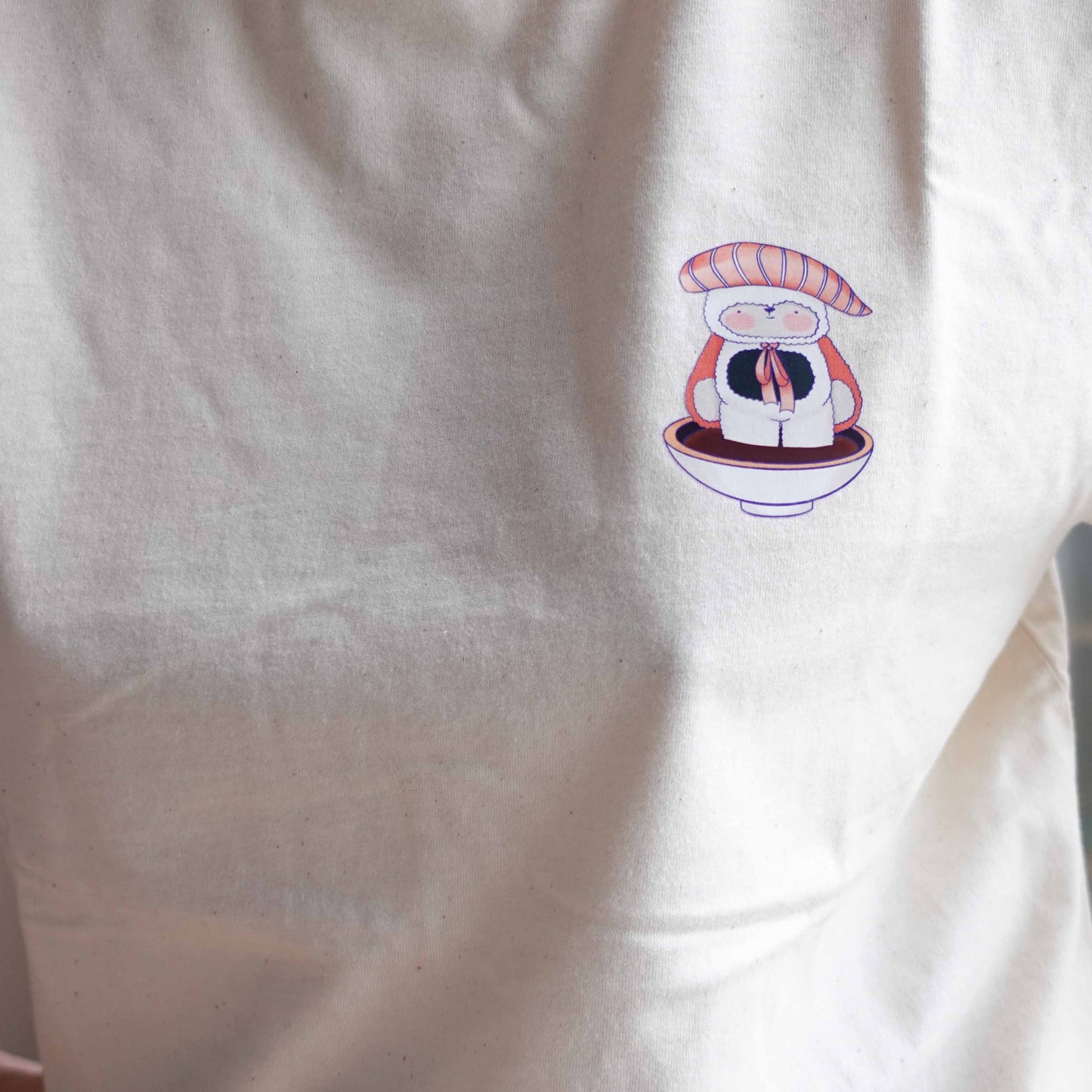 Front view and close up of the Fluff Club t-shirt in natural raw color, featuring a original design by uncomfy cherry from the sashimi boy in a buddle of soy