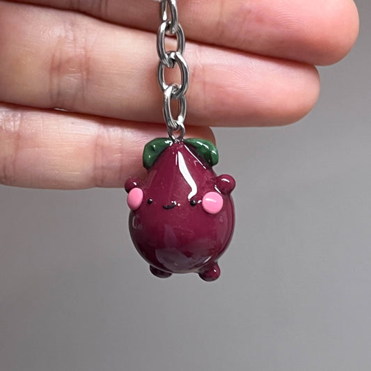 Handcrafted beetroot keychain made from polymer clay, featuring vibrant colors and a whimsical design, perfect for adding a touch of charm to your keys.