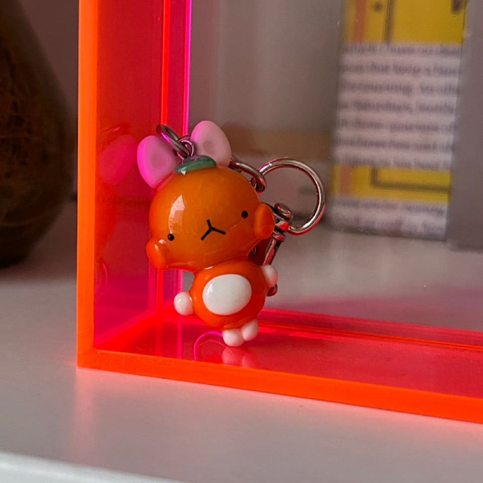 tangerine bunny keychain out of polymer clay and uv resin for durability. an all orange kawaii bunny creature to hang onto your purse, keys or bag or gift for your friends and family
