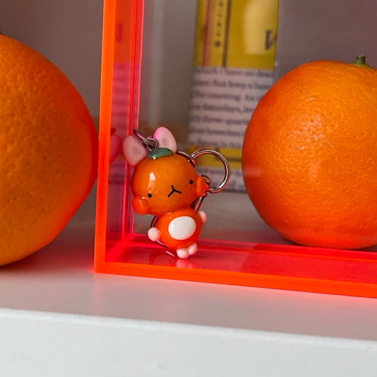 tangerine bunny keychain out of polymer clay and uv resin for durability. an all orange kawaii bunny creature to hang onto your purse, keys or bag or gift for your friends and family