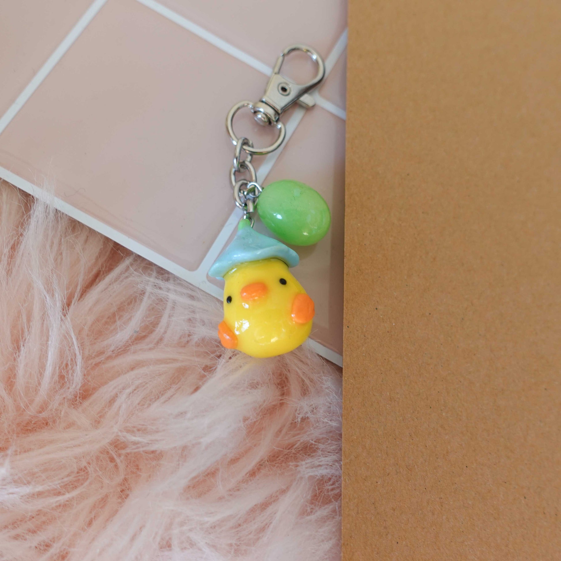 Adorable duckling keychain, featuring a fluffy design that brings a smile wherever you go.