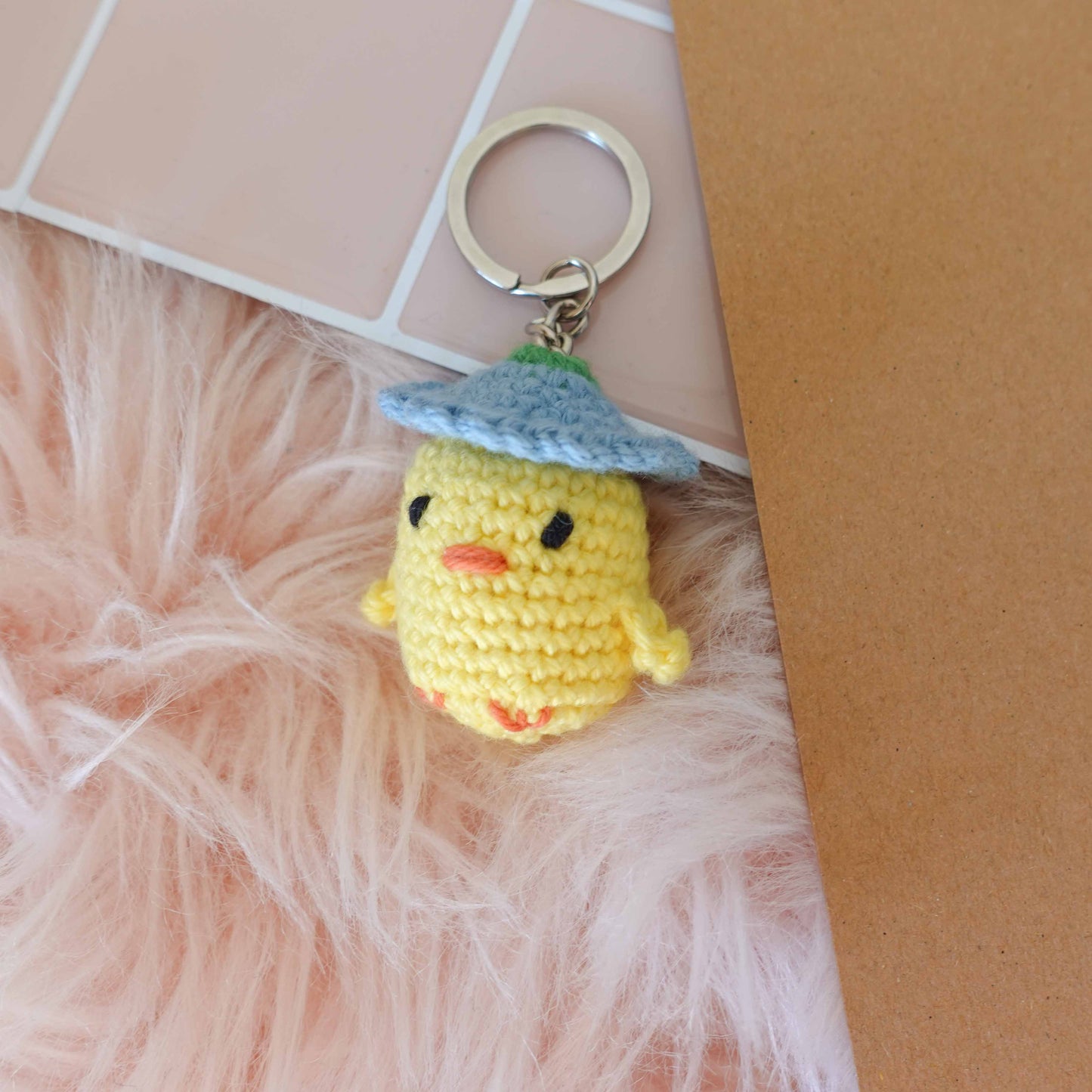 Handcrafted crochet duckling keychain, showcasing unique artistry and soft textures for a delightful touch.