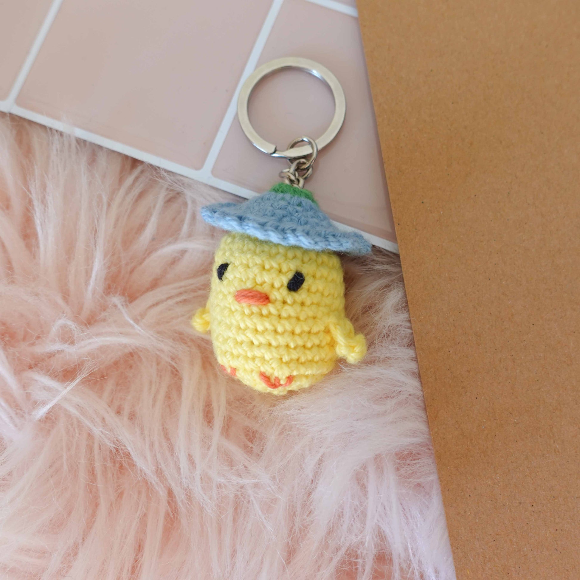 Handcrafted crochet duckling keychain, showcasing unique artistry and soft textures for a delightful touch.