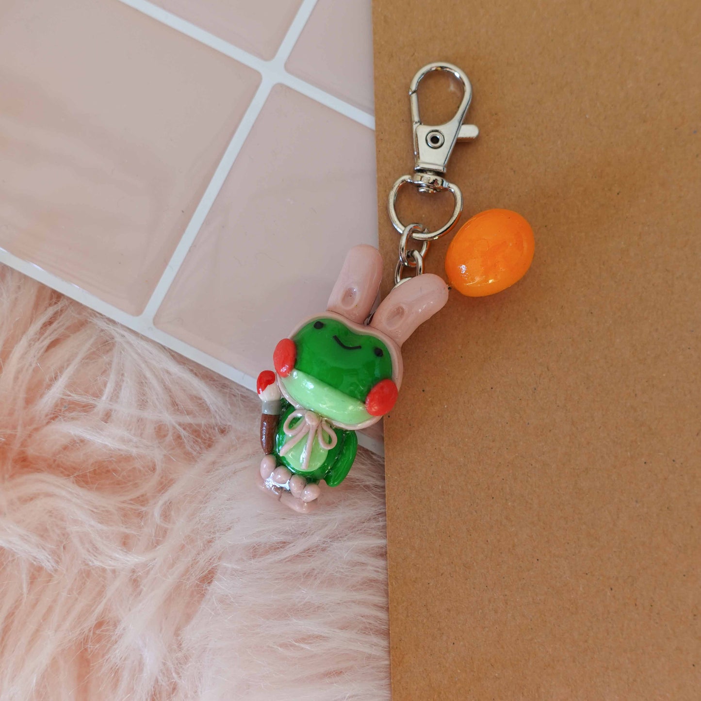 Whimsical frog bunny keychain combining two playful designs into one adorable accessory ideal for spring.