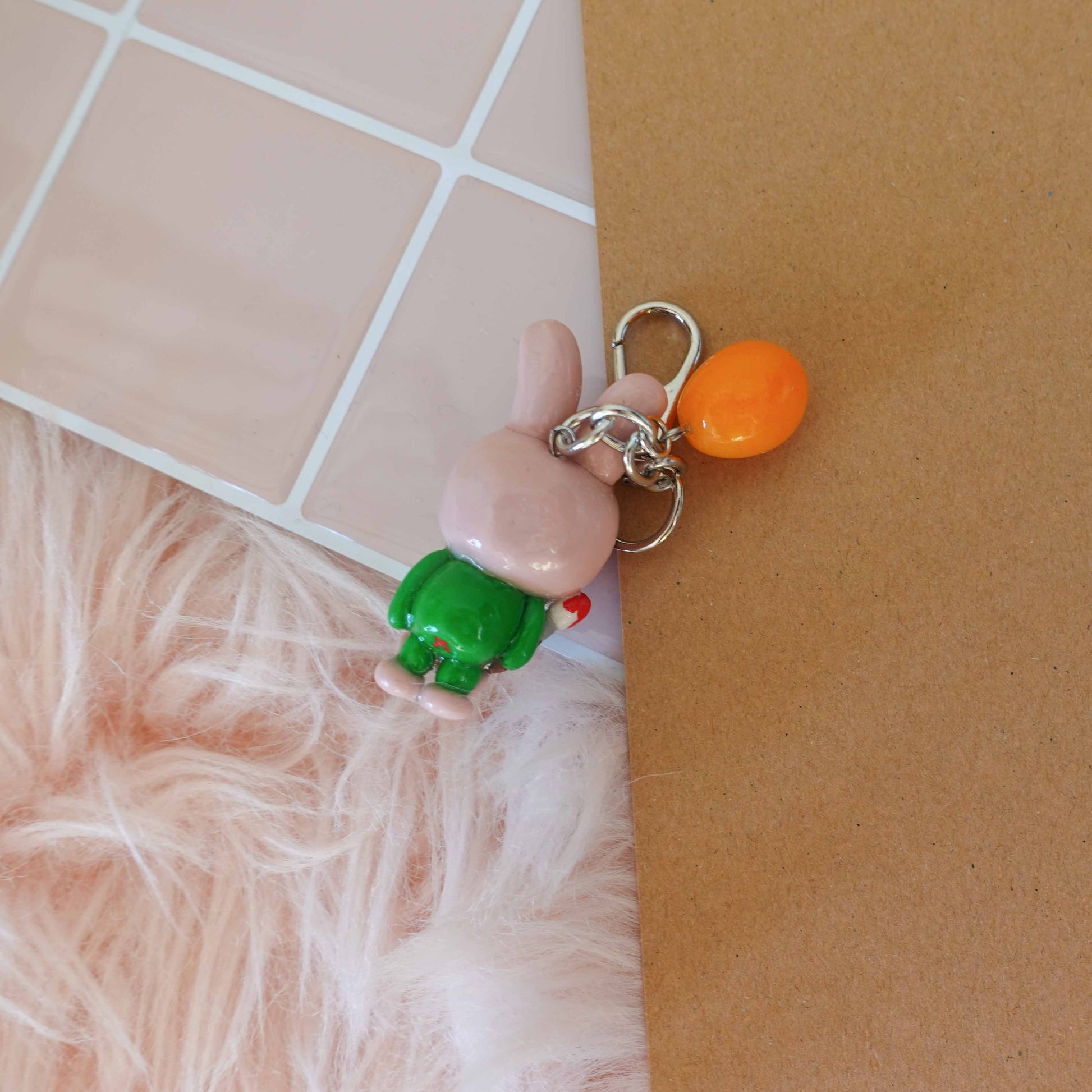 Whimsical frog bunny keychain combining two playful designs into one adorable accessory ideal for spring.