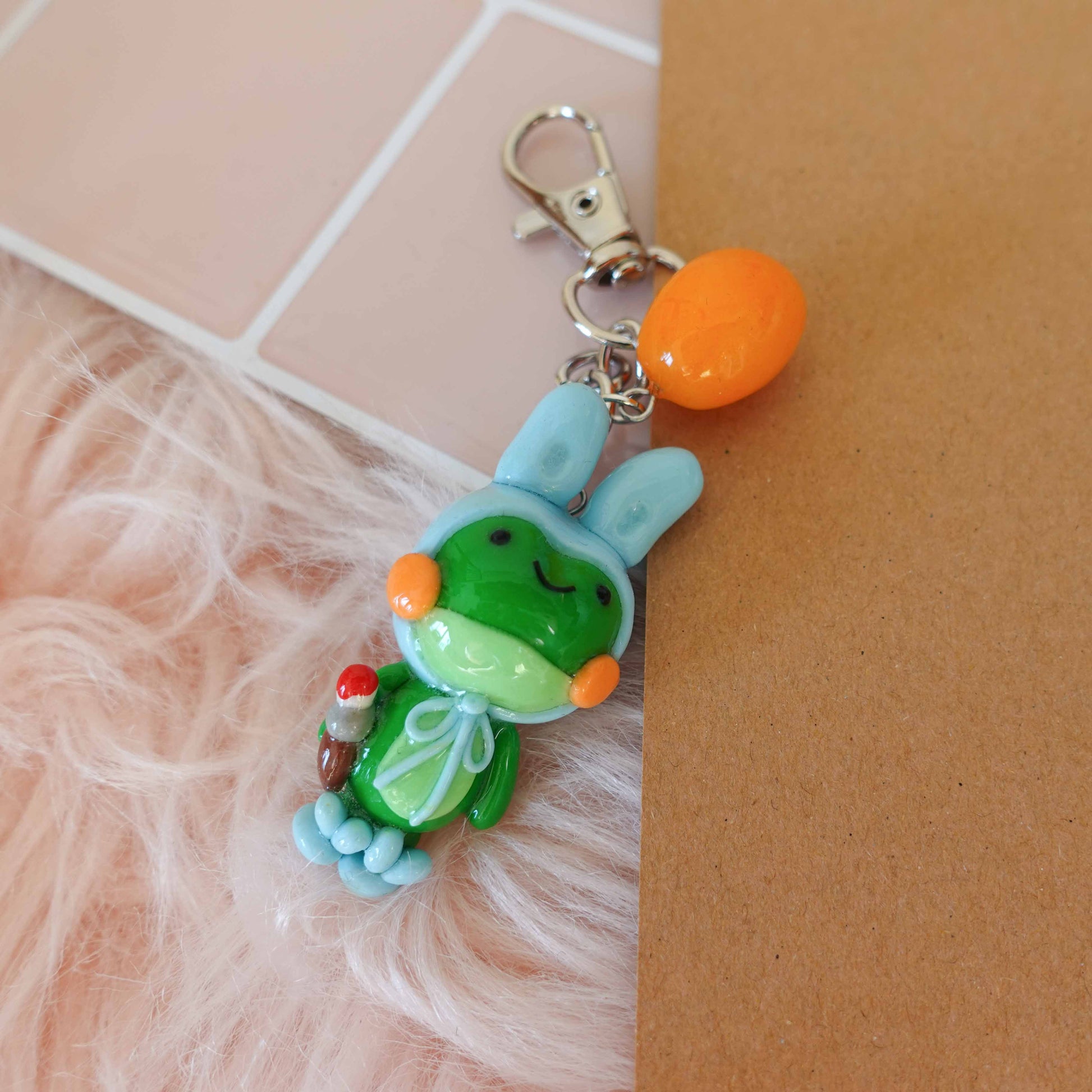 Whimsical frog bunny keychain combining two playful designs into one adorable accessory ideal for spring.