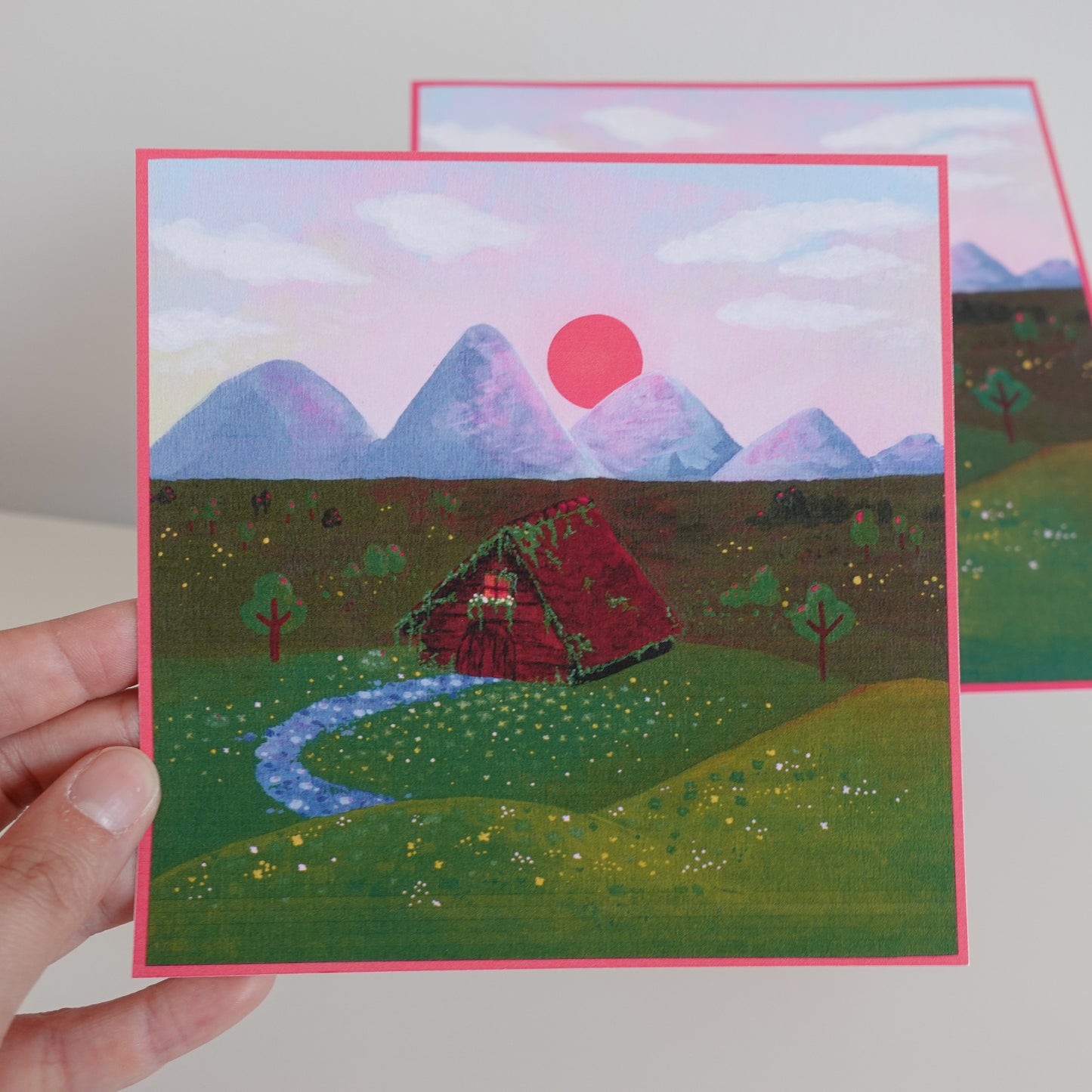 Close-up of the cozy cottage on the print, showing detailed and warm colors within the forest setting.