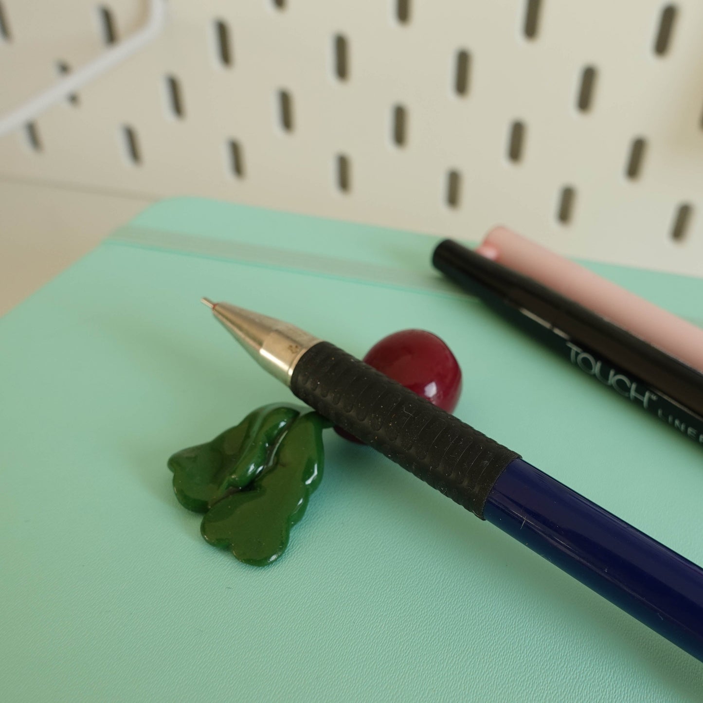 Handcrafted beetroot chopstick holder made from polymer clay, featuring vibrant colors and a playful neon pink butthole detail, suitable for use as a pen or brush holder.