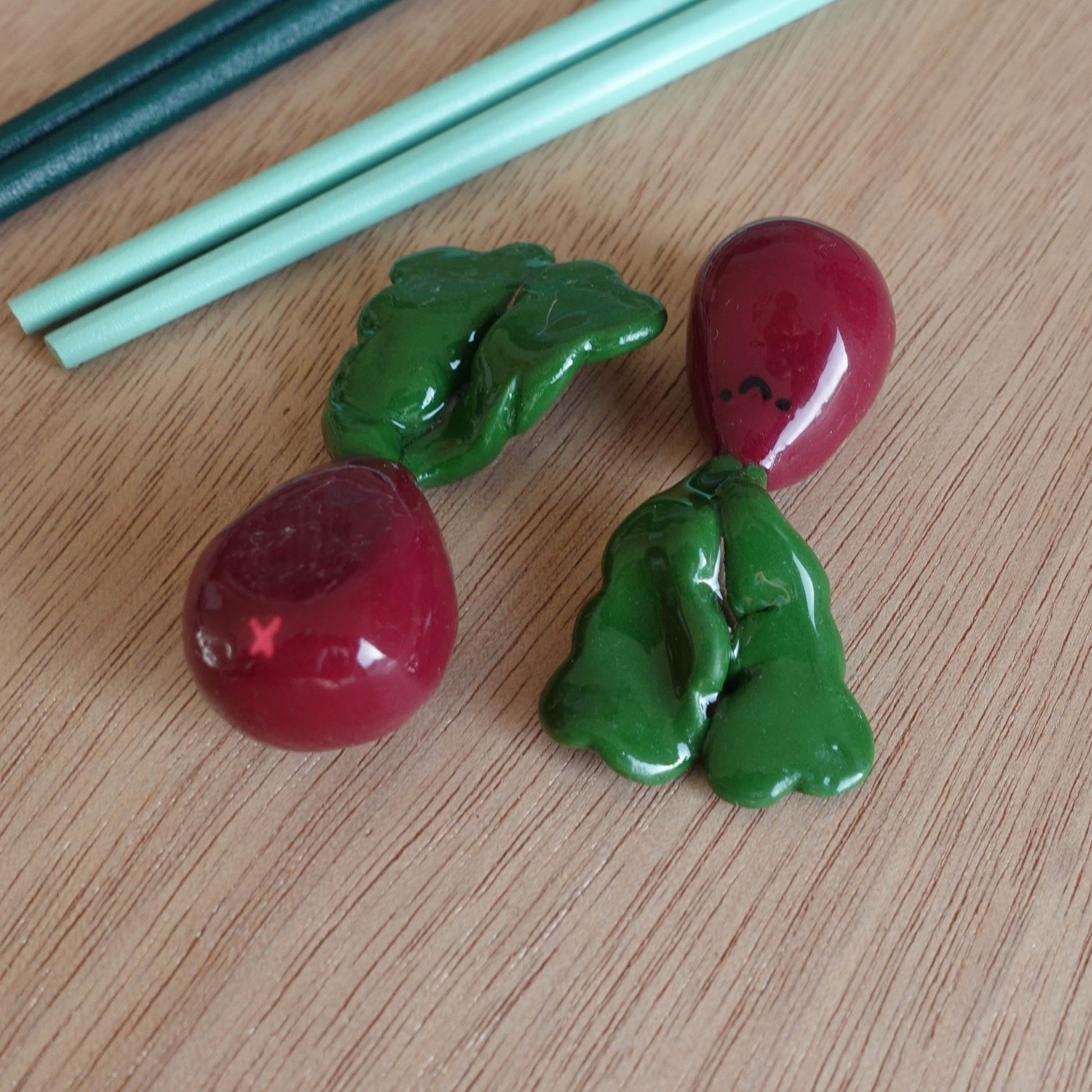 Handcrafted beetroot chopstick holder made from polymer clay, featuring vibrant colors and a playful neon pink butthole detail, suitable for use as a pen or brush holder.Handcrafted beetroot chopstick holder made from polymer clay, featuring vibrant colors and a playful neon pink butthole detail, suitable for use as a pen or brush holder.