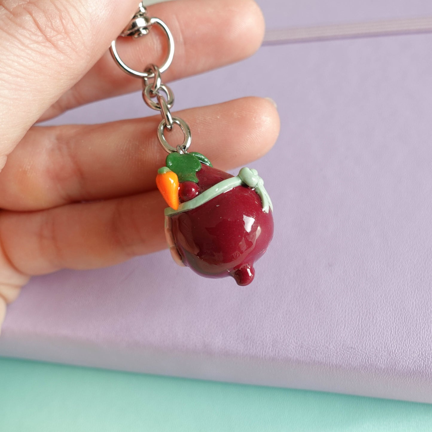 Handcrafted beetroot keychain made from polymer clay, featuring vibrant colors and a whimsical design, perfect for adding a touch of charm to your keys.