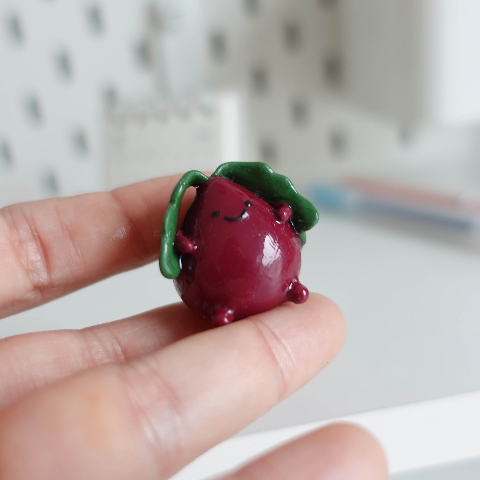 Handcrafted beetroot desk friend made from polymer clay, featuring vibrant colors and a charming design, perfect for adding whimsy to your workspace.