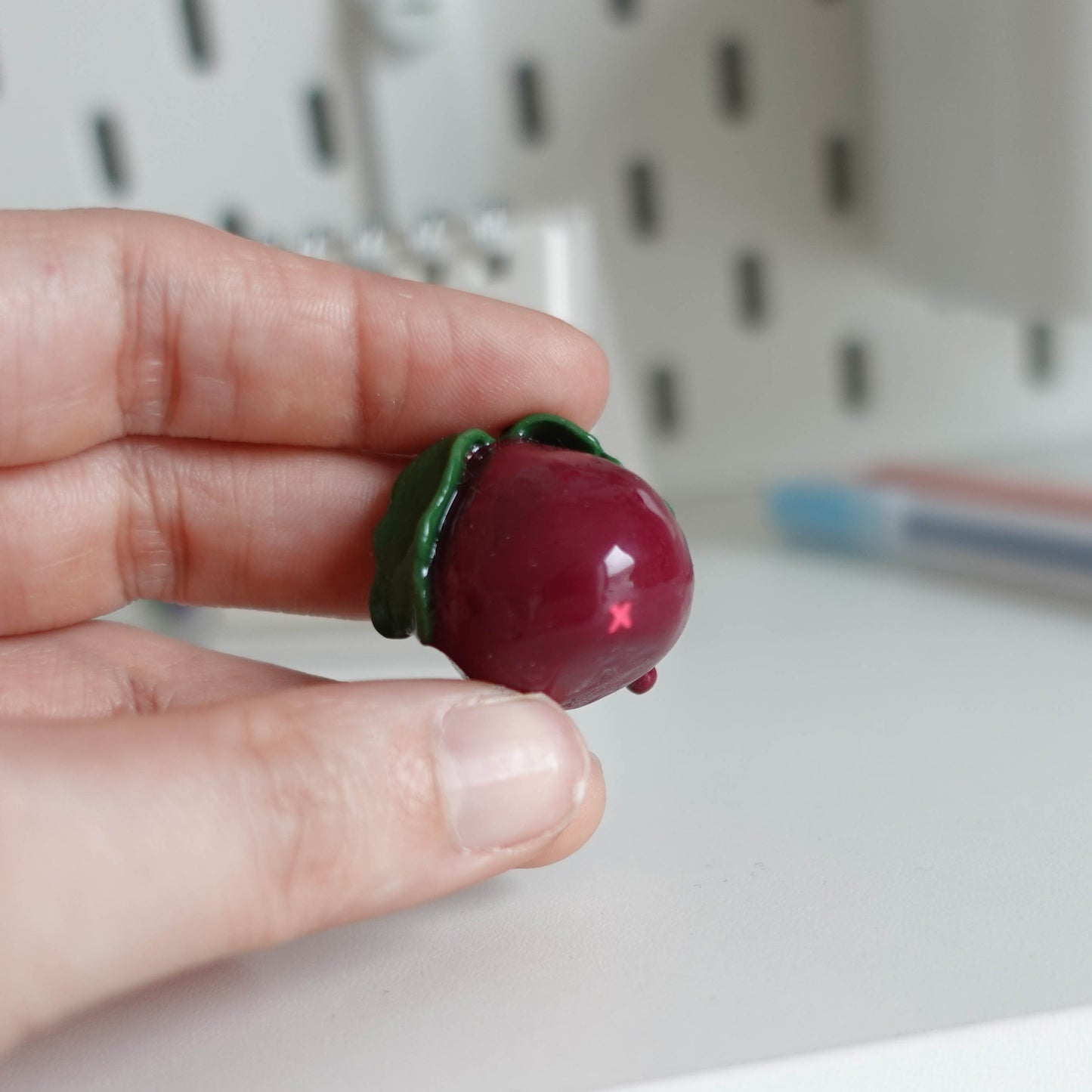 Handcrafted beetroot desk friend made from polymer clay, featuring vibrant colors and a charming design, perfect for adding whimsy to your workspace.