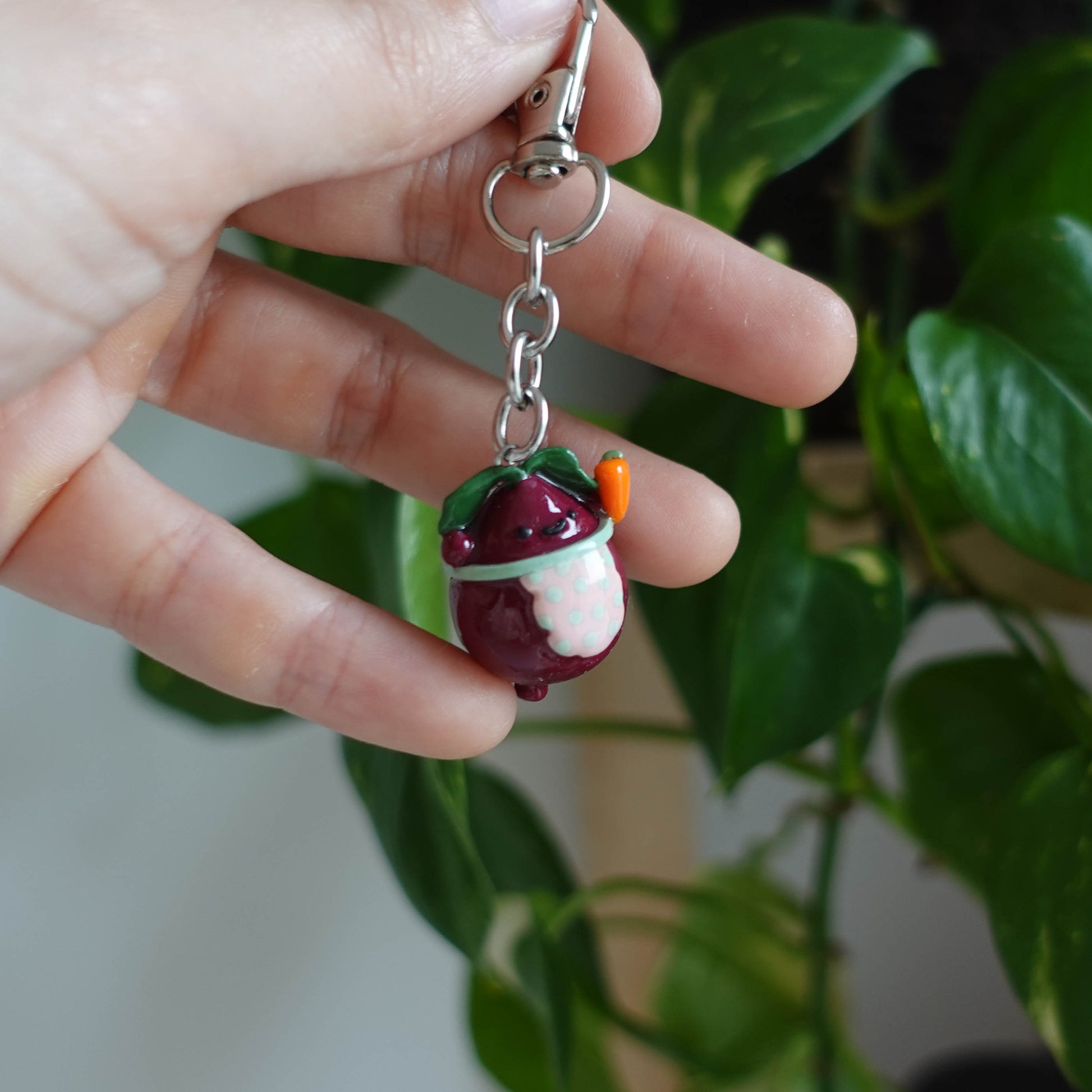 Handcrafted beetroot keychain made from polymer clay, featuring vibrant colors and a whimsical design, perfect for adding a touch of charm to your keys.