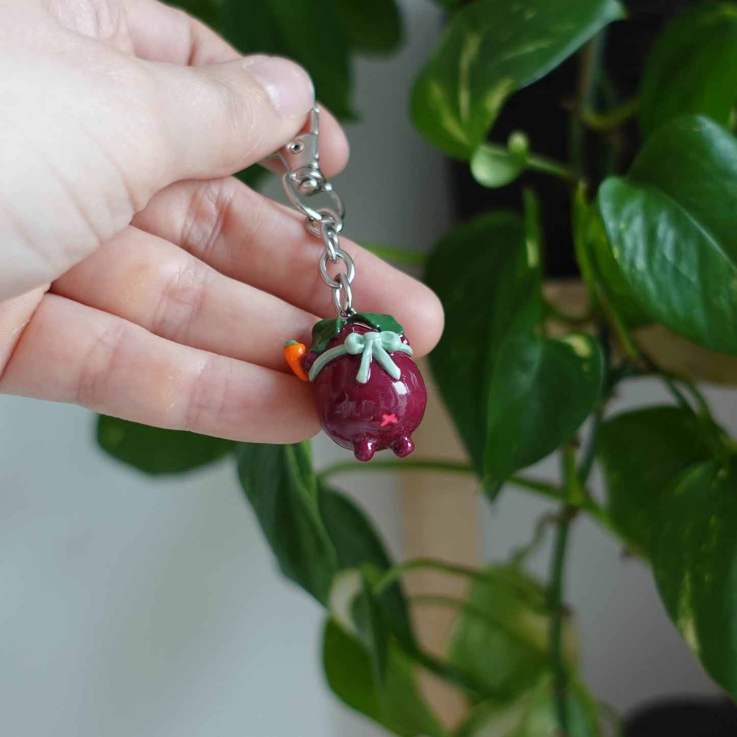 Handcrafted beetroot keychain made from polymer clay, featuring vibrant colors and a whimsical design, perfect for adding a touch of charm to your keys.