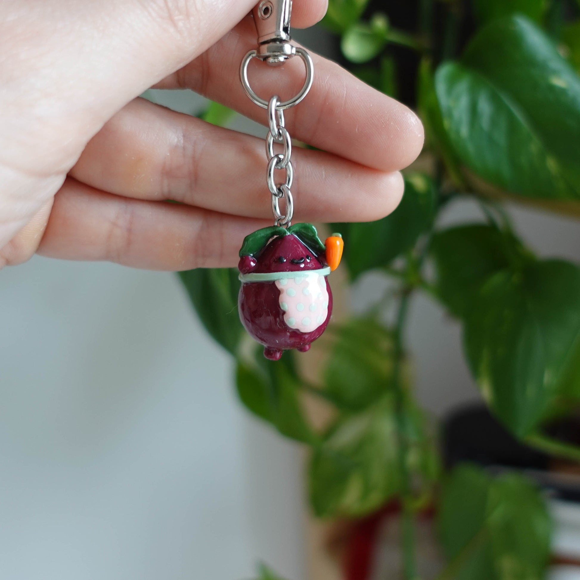 Handcrafted beetroot keychain made from polymer clay, featuring vibrant colors and a whimsical design, perfect for adding a touch of charm to your keys.