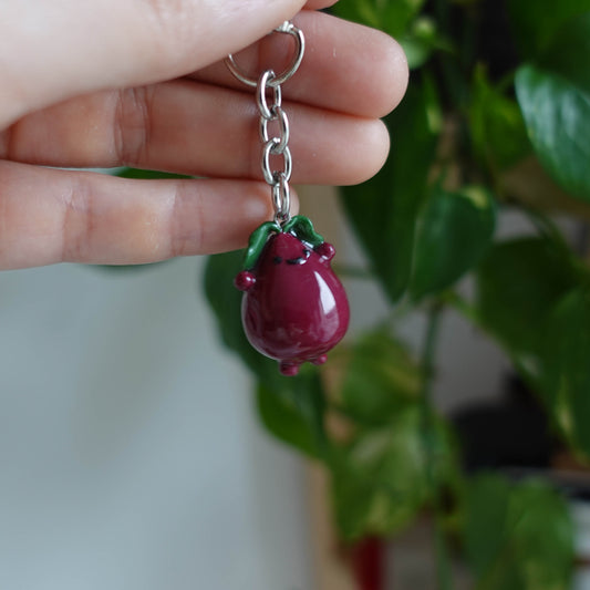 Handcrafted beetroot keychain made from polymer clay, featuring vibrant colors and a whimsical design, perfect for adding a touch of charm to your keys.