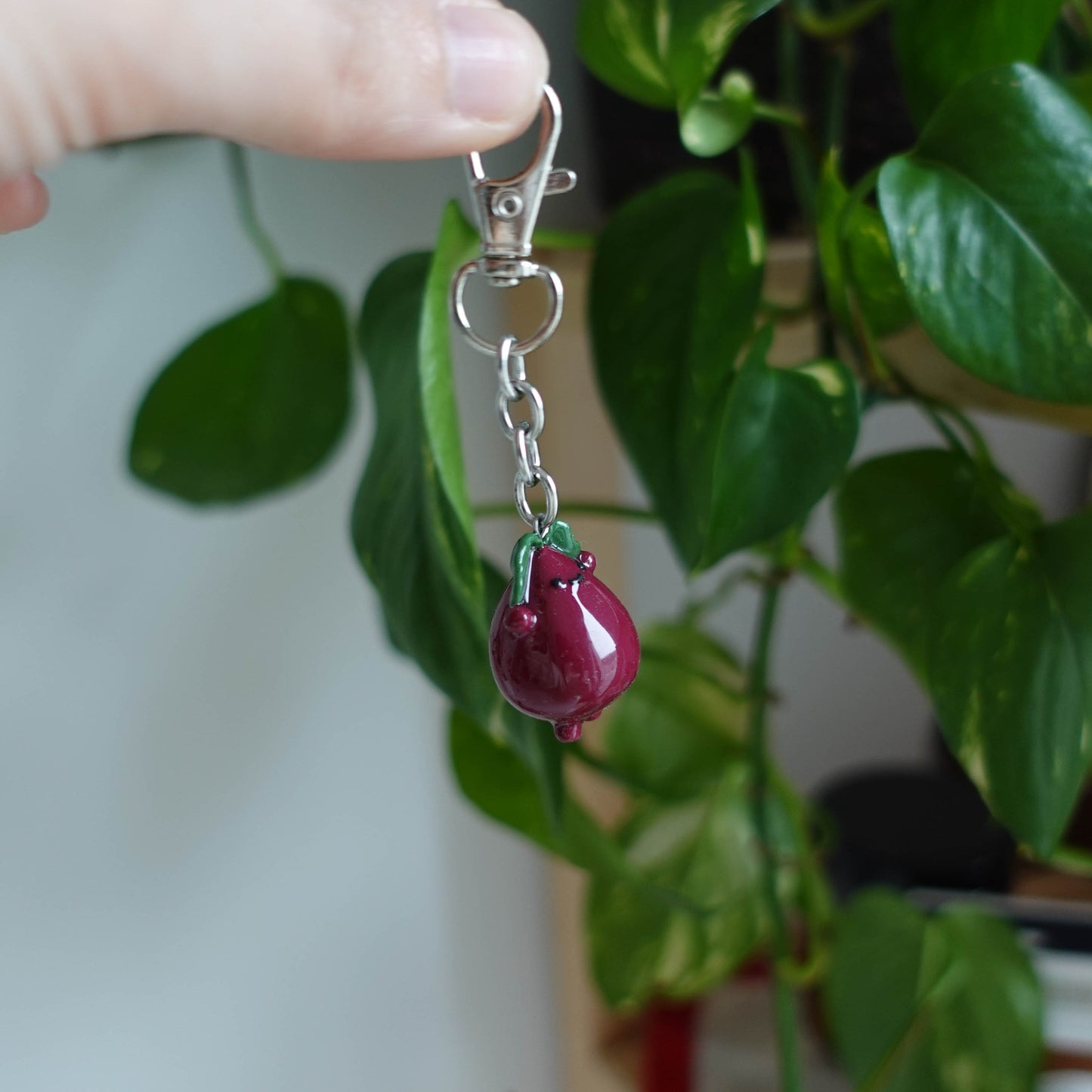 Handcrafted beetroot keychain made from polymer clay, featuring vibrant colors and a whimsical design, perfect for adding a touch of charm to your keys.