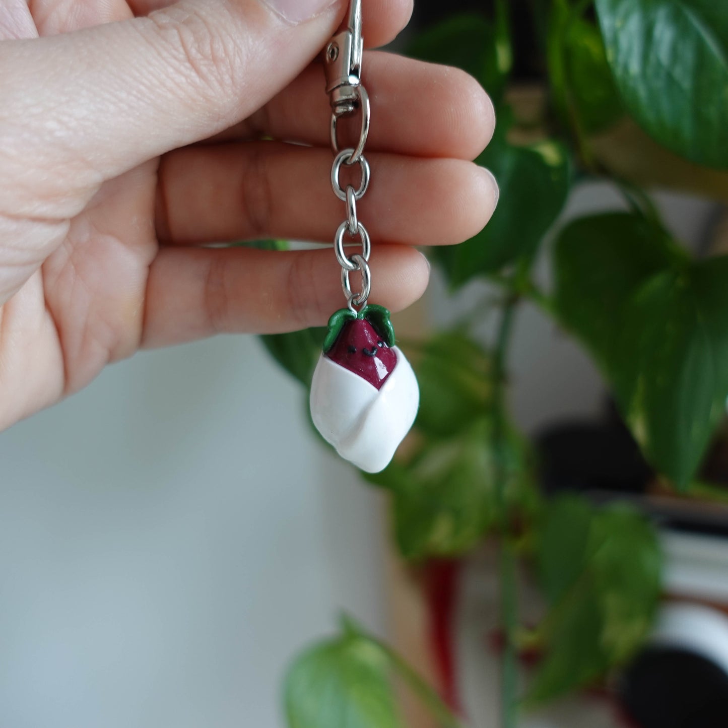 Handcrafted beetroot keychain made from polymer clay, featuring vibrant colors and a whimsical design, perfect for adding a touch of charm to your keys.