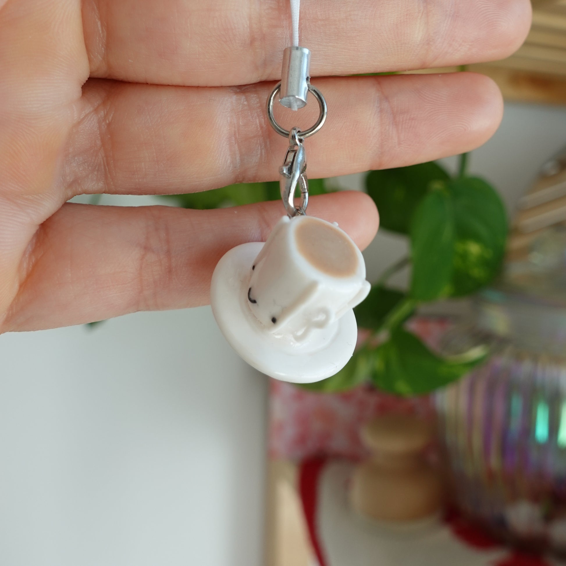 Tea Cup Phone Charm: A miniature tea cup charm, adding a touch of elegance to your phone accessory.