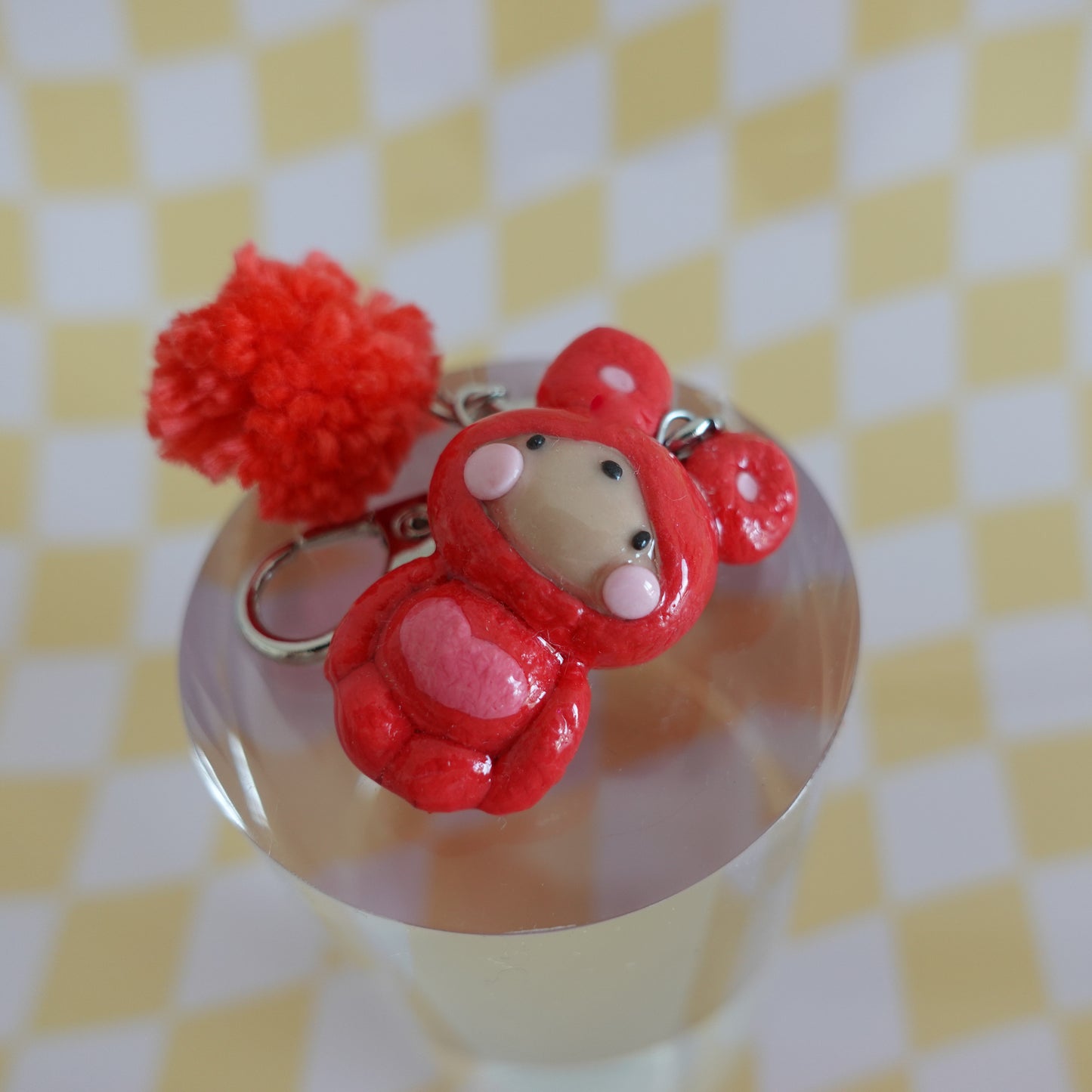 Detailed view of a handmade polymer clay keychain with an extra charm fluff, highlighting the texture and playful design.