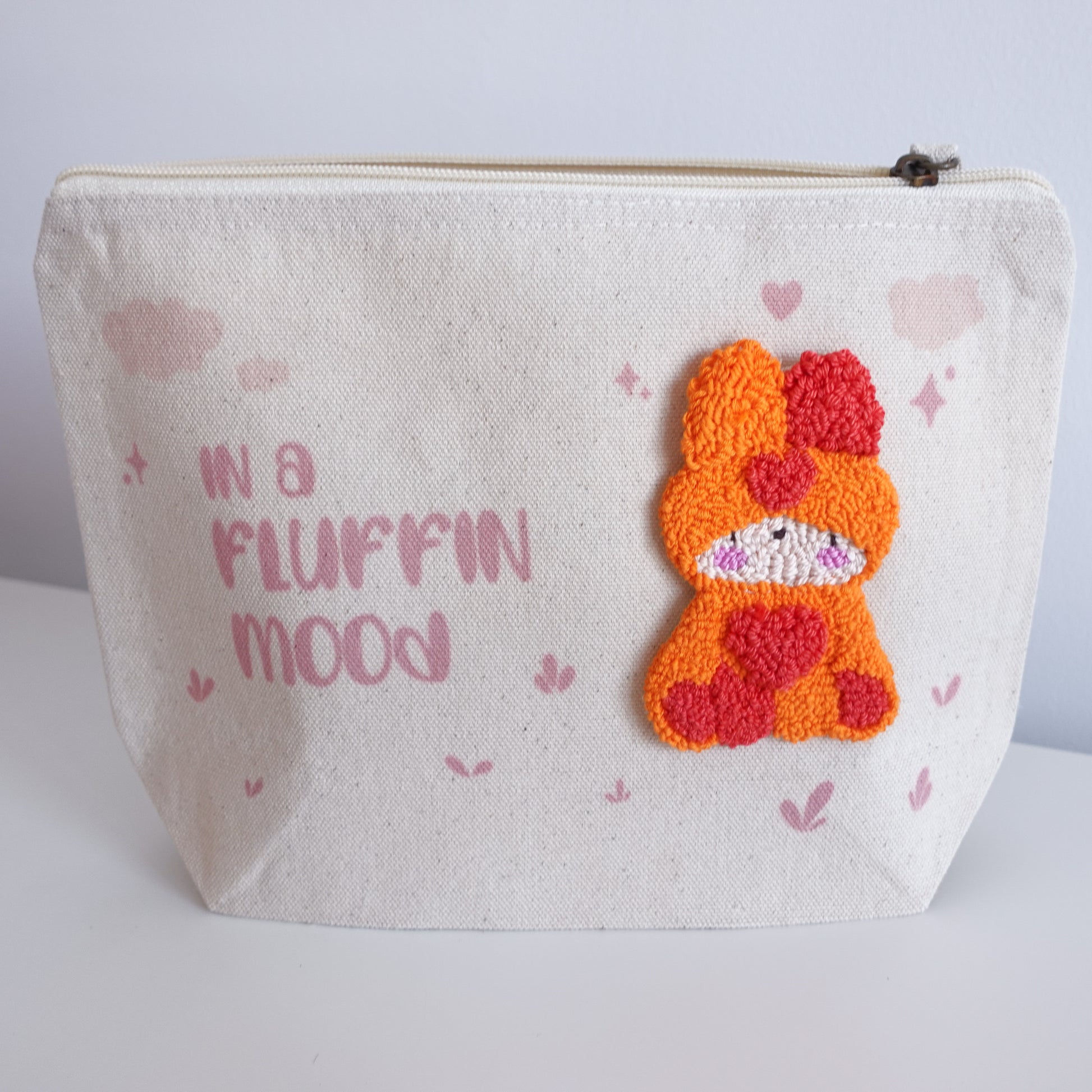 Two variations of the Fluff Club craft pouch made from fair trade cotton, each featuring a unique print and punch needle fluff detail.