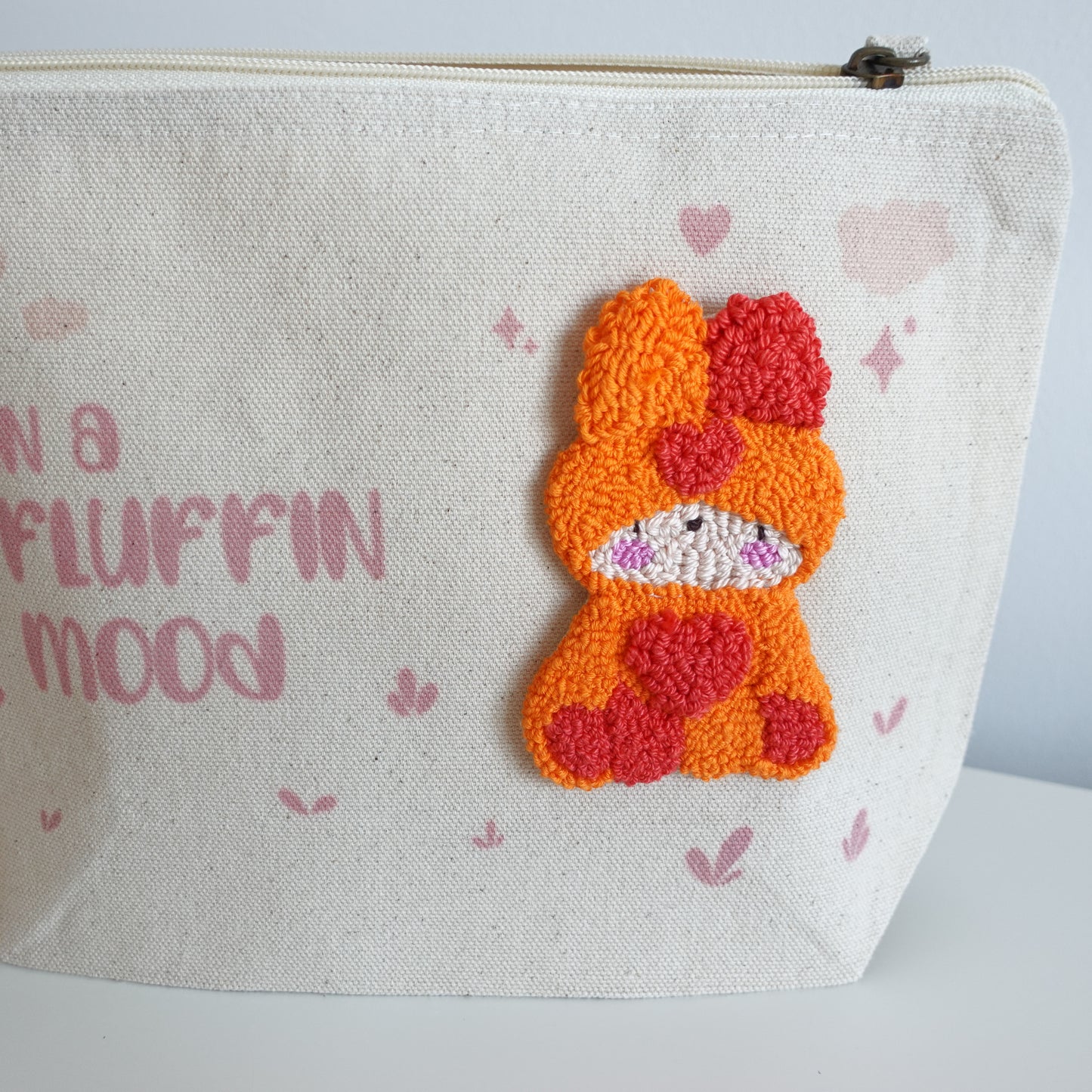 Fluff Club craft pouch filled with crafting supplies, demonstrating its functionality and design.