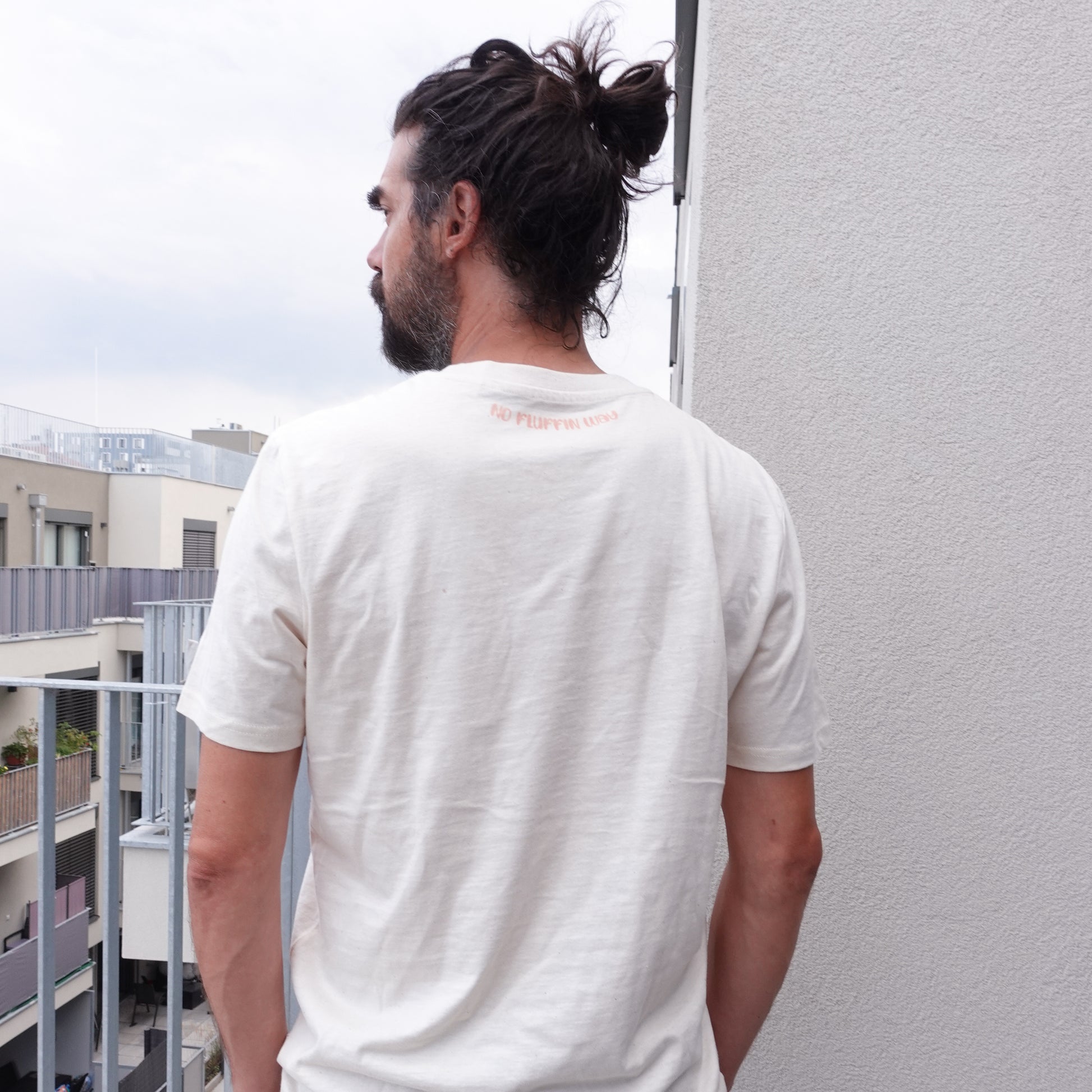 back view of the Fluff Club punch needle t-shirt in natural raw color, featuring a handmade punch needle detail on the neckline.