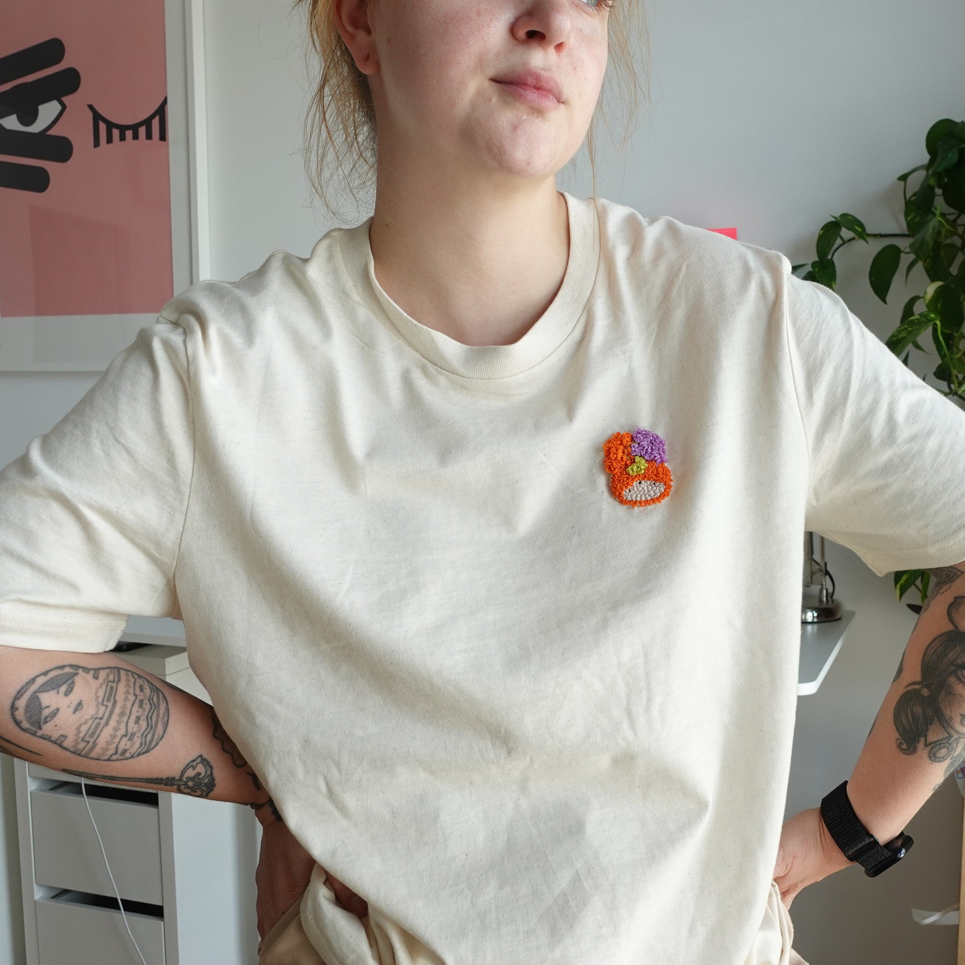 ront view of the Fluff Club punch needle t-shirt in natural raw color, featuring a handmade punch needle detail on the chest.