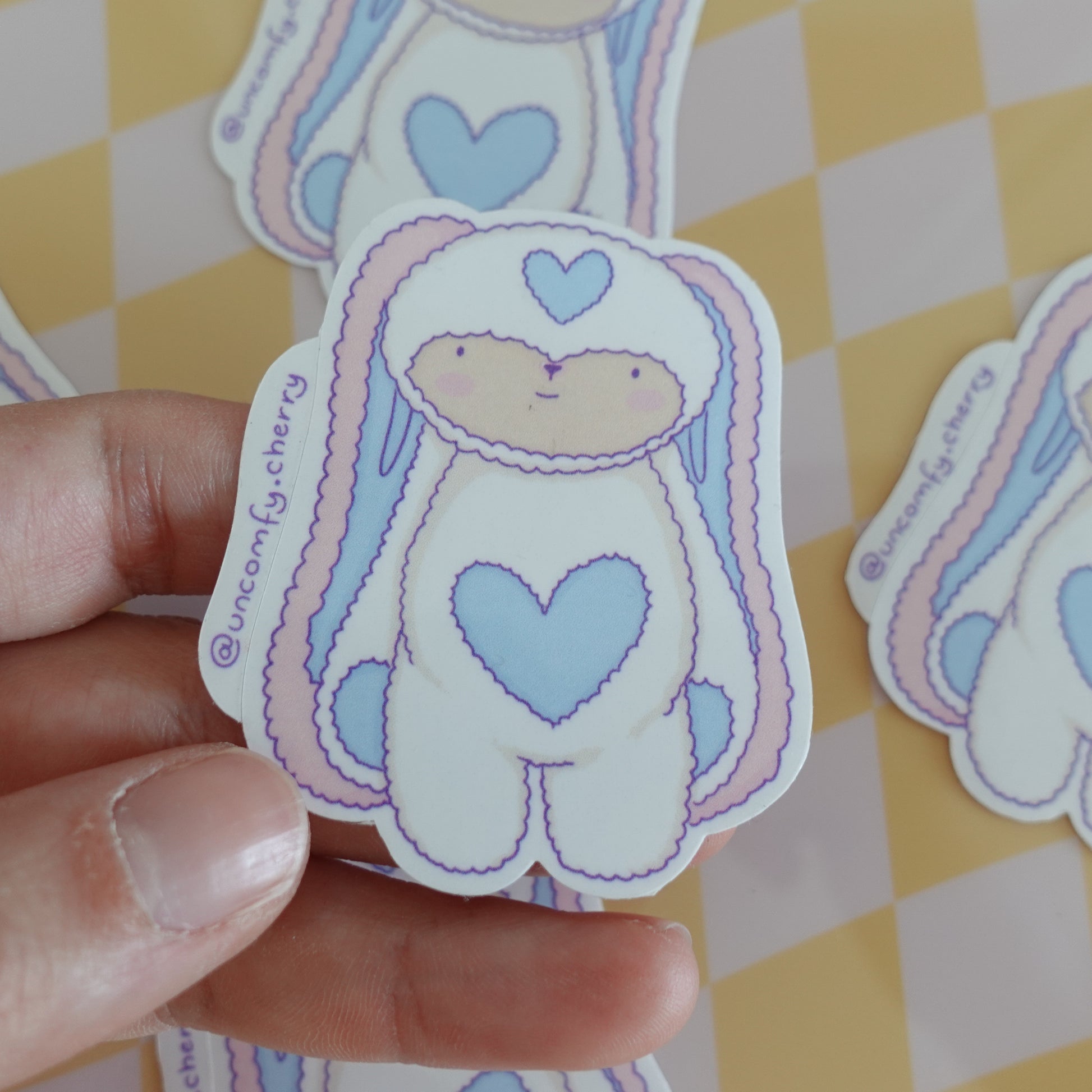 Close-up of the Fluff Club glossy vinyl stickers, emphasizing their shiny finish and vibrant colors.