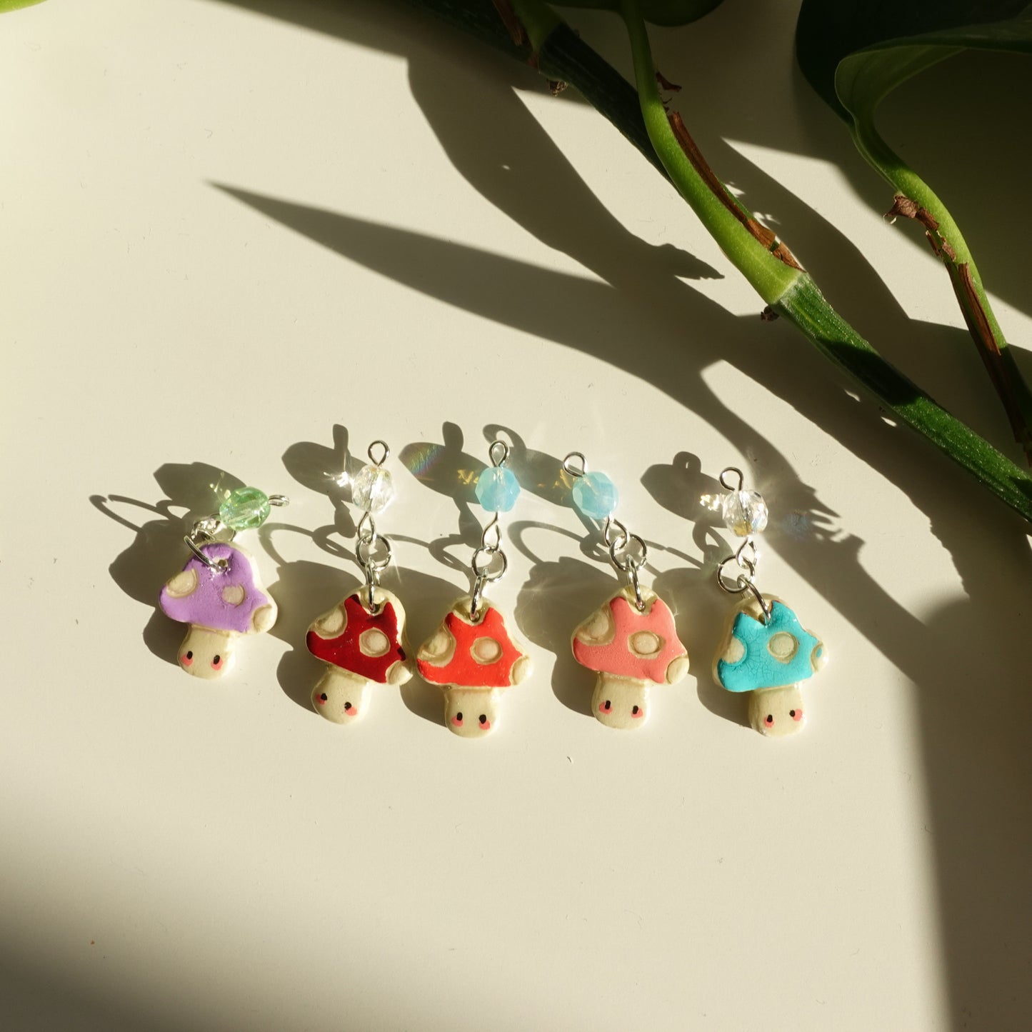 mushroom lucky charms, showing all five different colors of the new years lucky charm keychains.