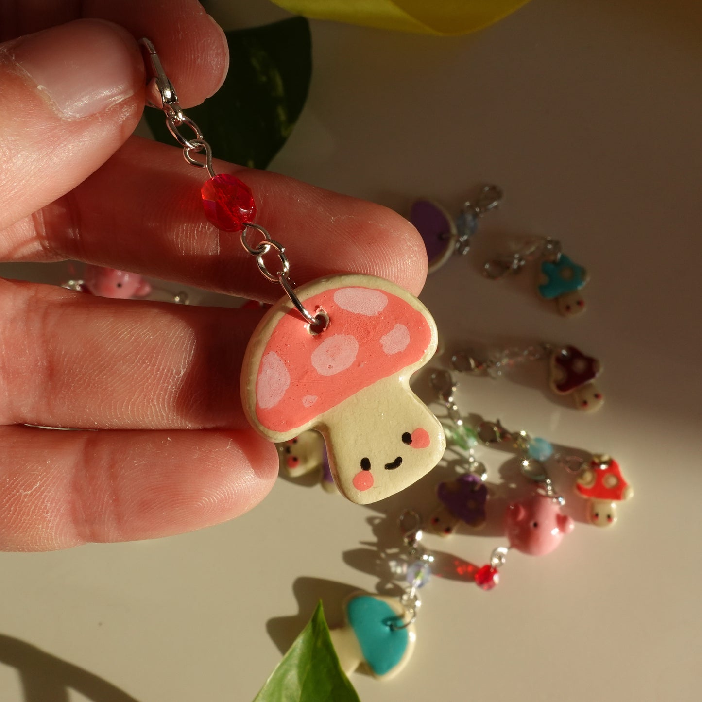 mushroom lucky charm keychain in pink with dots and a red bead for extra added sparkle. clay charm resined to make them durable. perfect new years gift or present for the holidays to any kawaii lover and mushroom lover