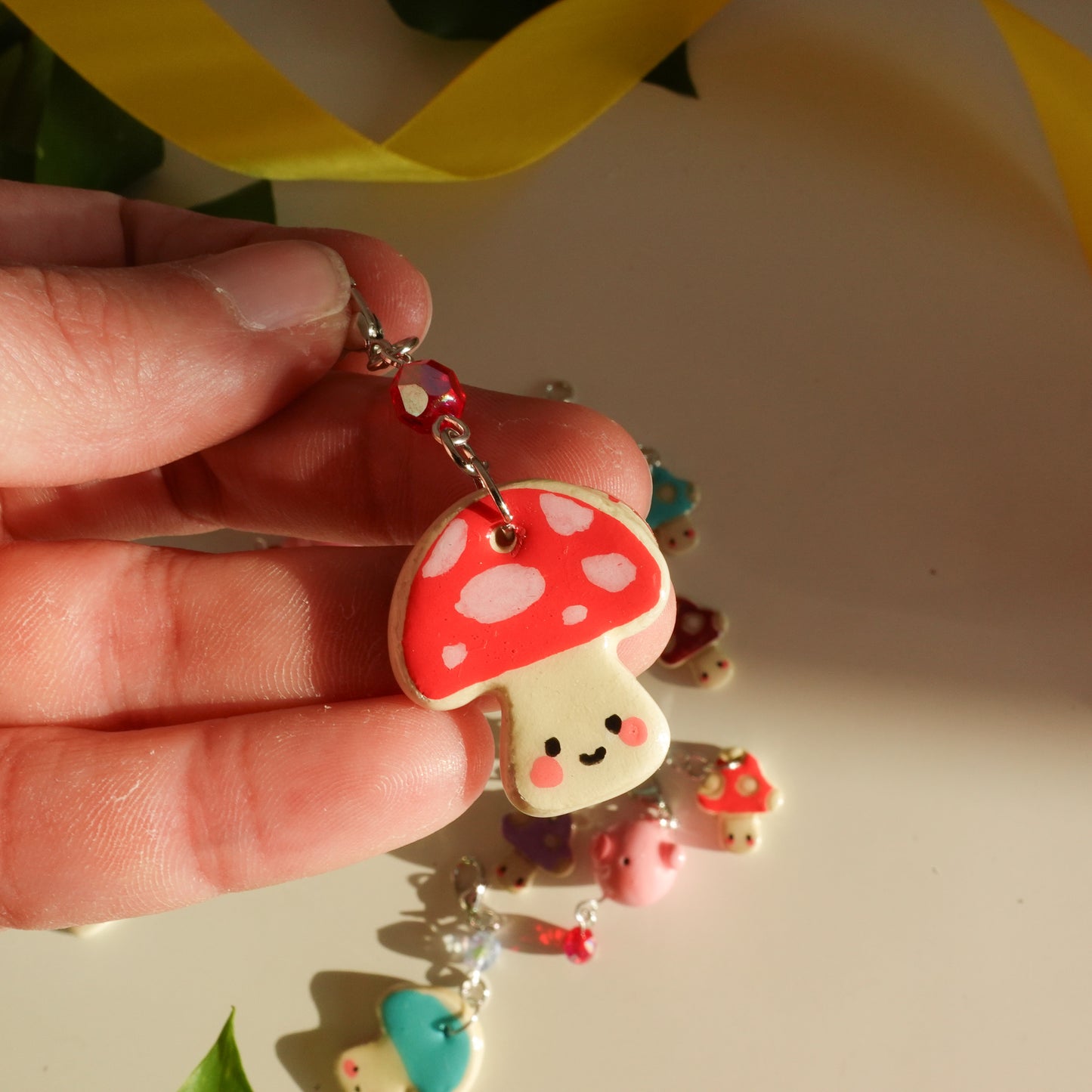 mushroom lucky charm keychain in red with dots and a red bead for extra added sparkle. clay charm resined to make them durable. perfect new years gift or present for the holidays to any kawaii lover and mushroom lover