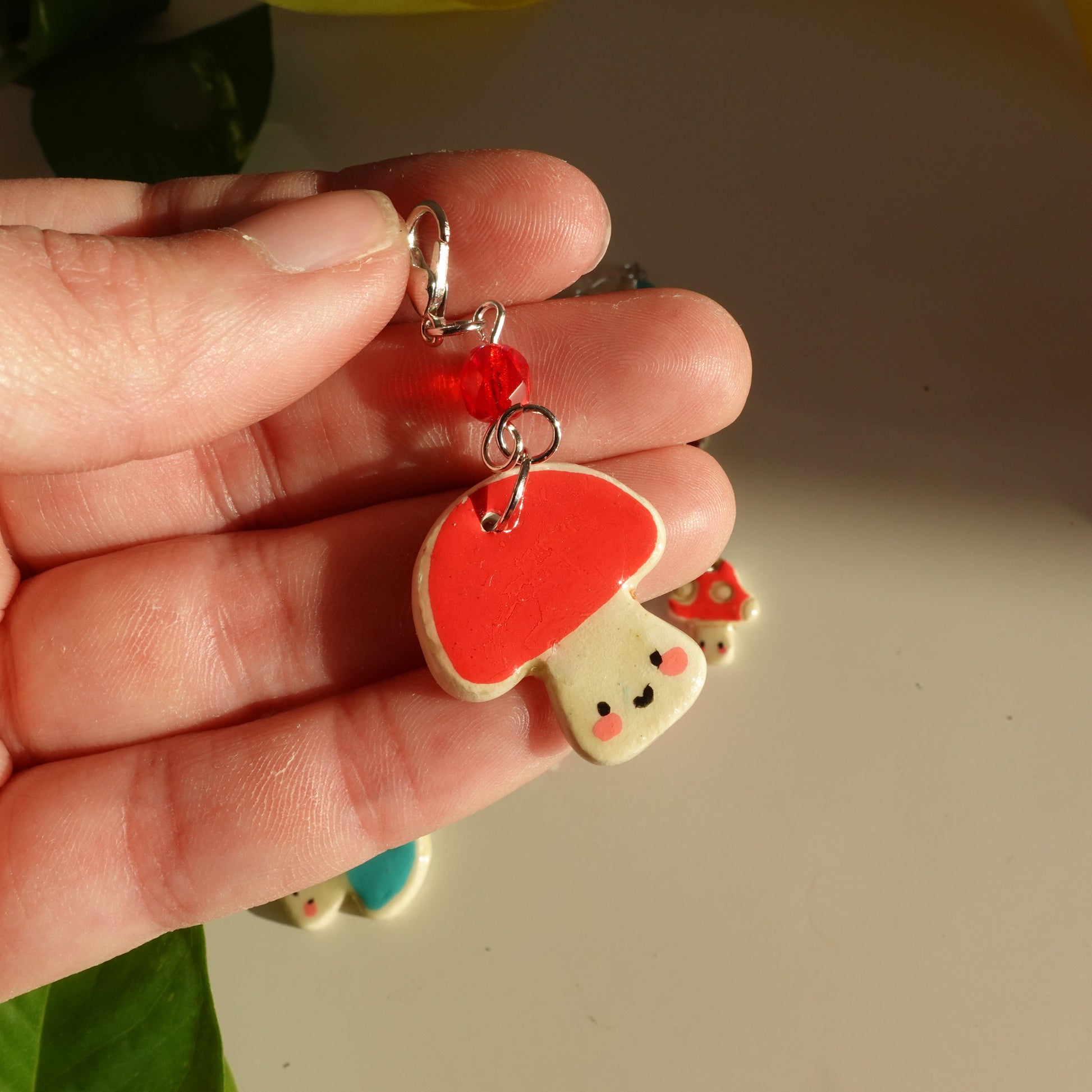 mushroom lucky charm keychain in red  and a red bead for extra added sparkle. clay charm resined to make them durable. perfect new years gift or present for the holidays to any kawaii lover and mushroom lover