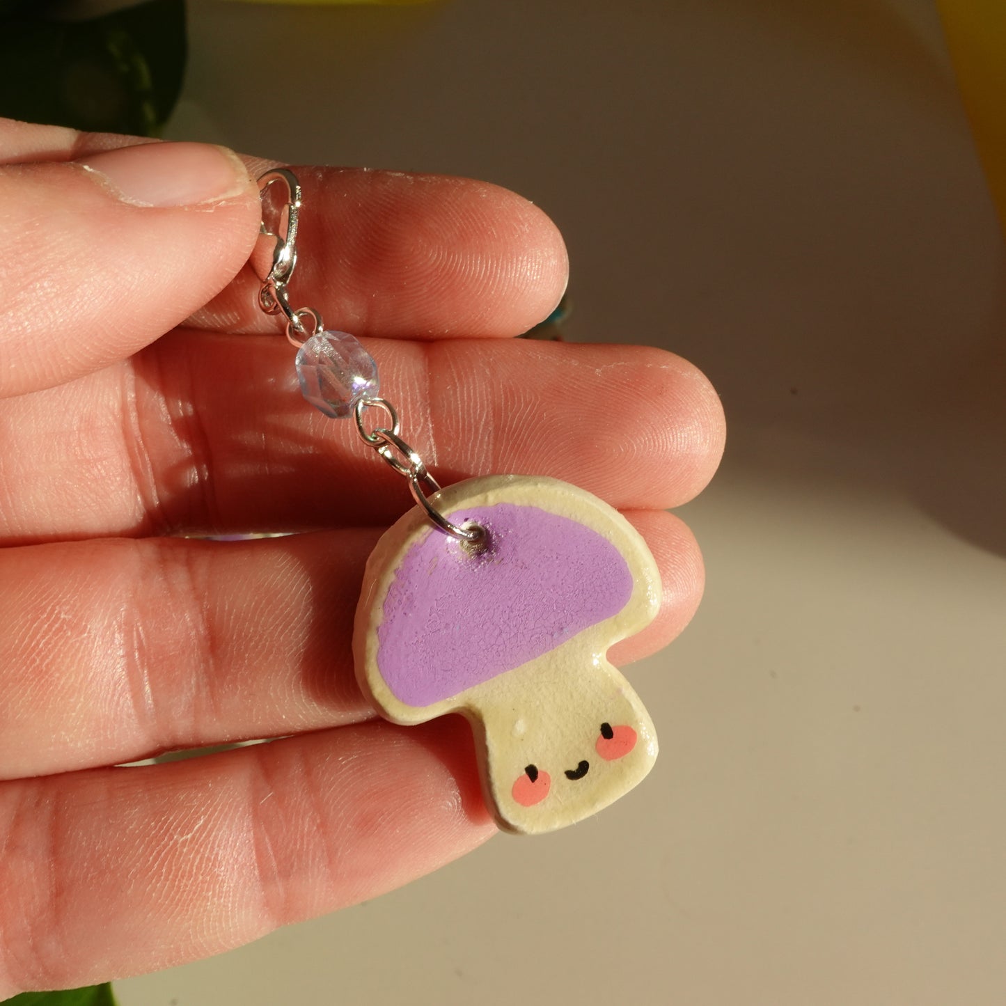 mushroom lucky charm keychain in lilac and a red bead for extra added sparkle. clay charm resined to make them durable. perfect new years gift or present for the holidays to any kawaii lover and mushroom lover