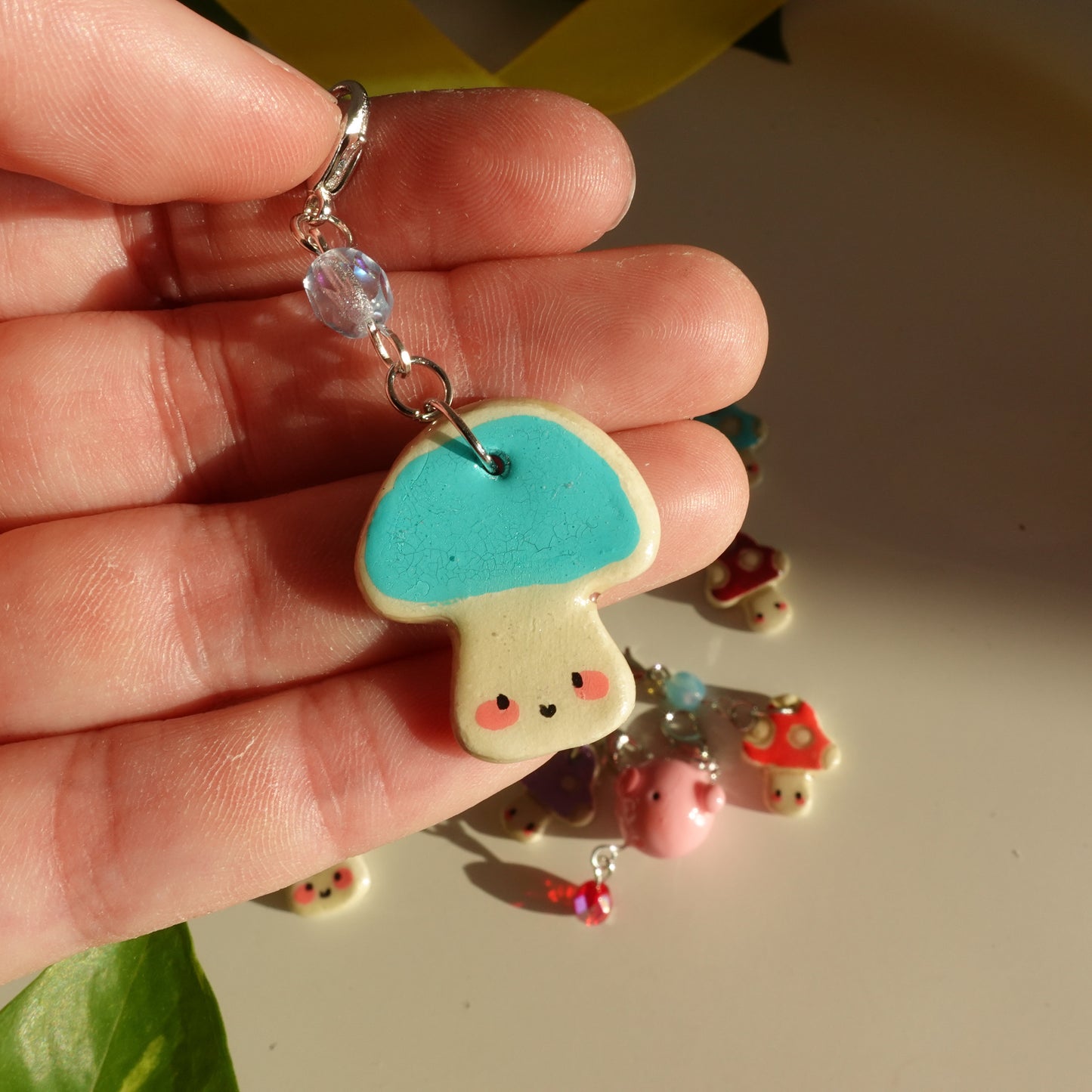 mushroom lucky charm keychain in teal and a red bead for extra added sparkle. clay charm resined to make them durable. perfect new years gift or present for the holidays to any kawaii lover and mushroom lover