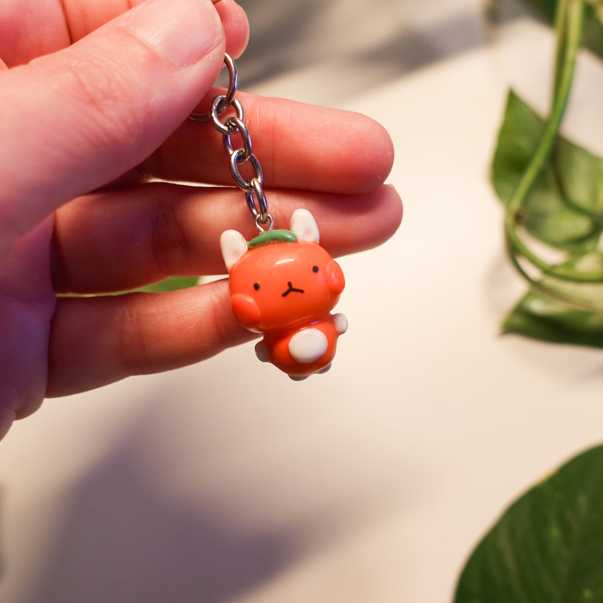 tangerine bunny keychain out of polymer clay and uv resin for durability. an all orange kawaii bunny creature to hang onto your purse, keys or bag or gift for your friends and family