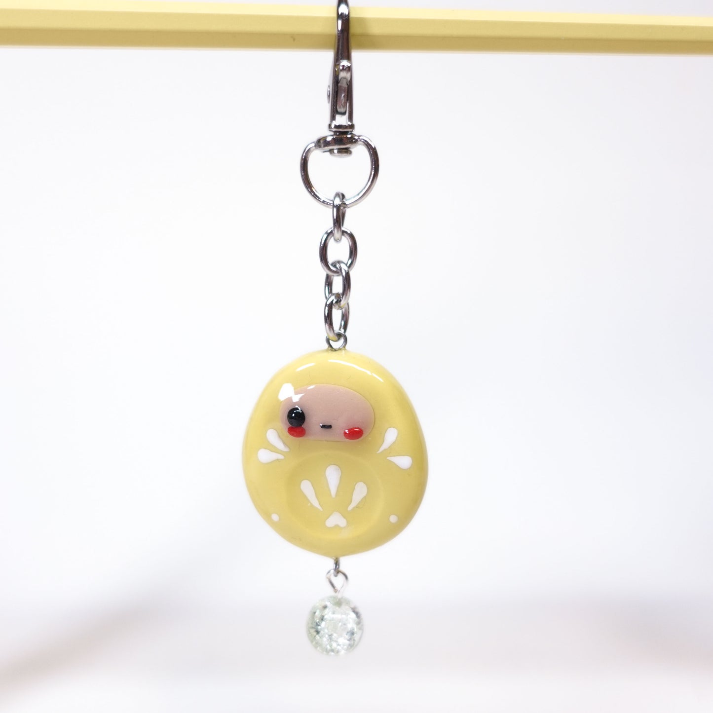 Aesthetic Daruma keychain that doubles as an anxiety relief tool