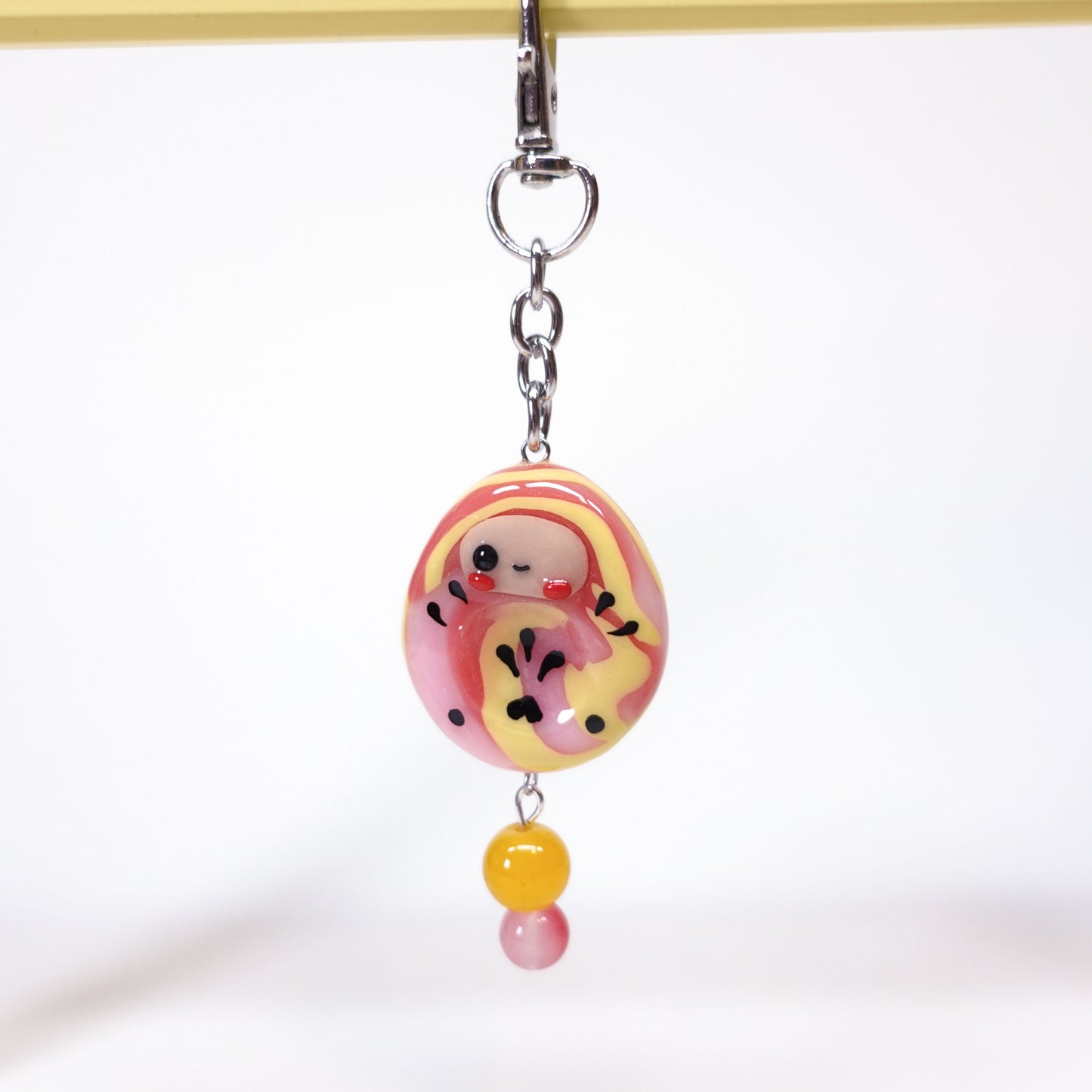 Daruma worry stone keychain for anxiety relief attached to keys