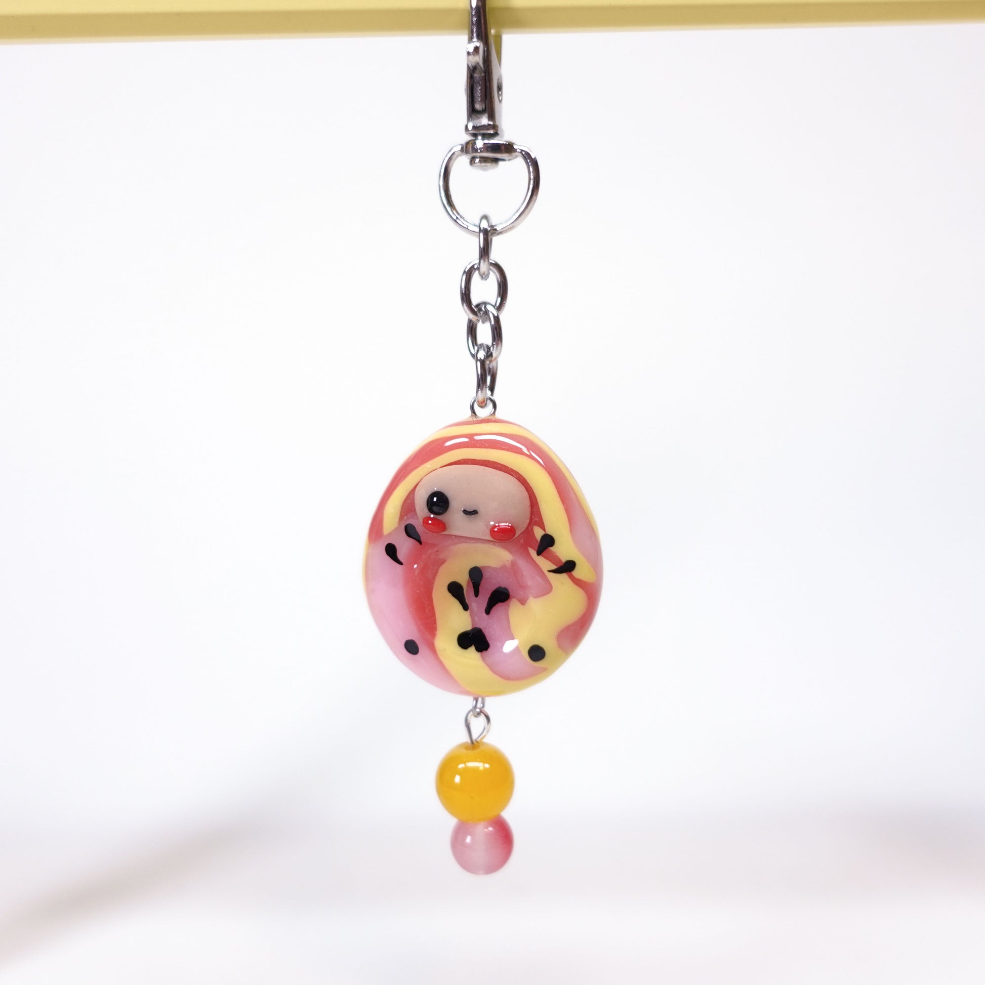 Daruma worry stone keychain for anxiety relief attached to keys