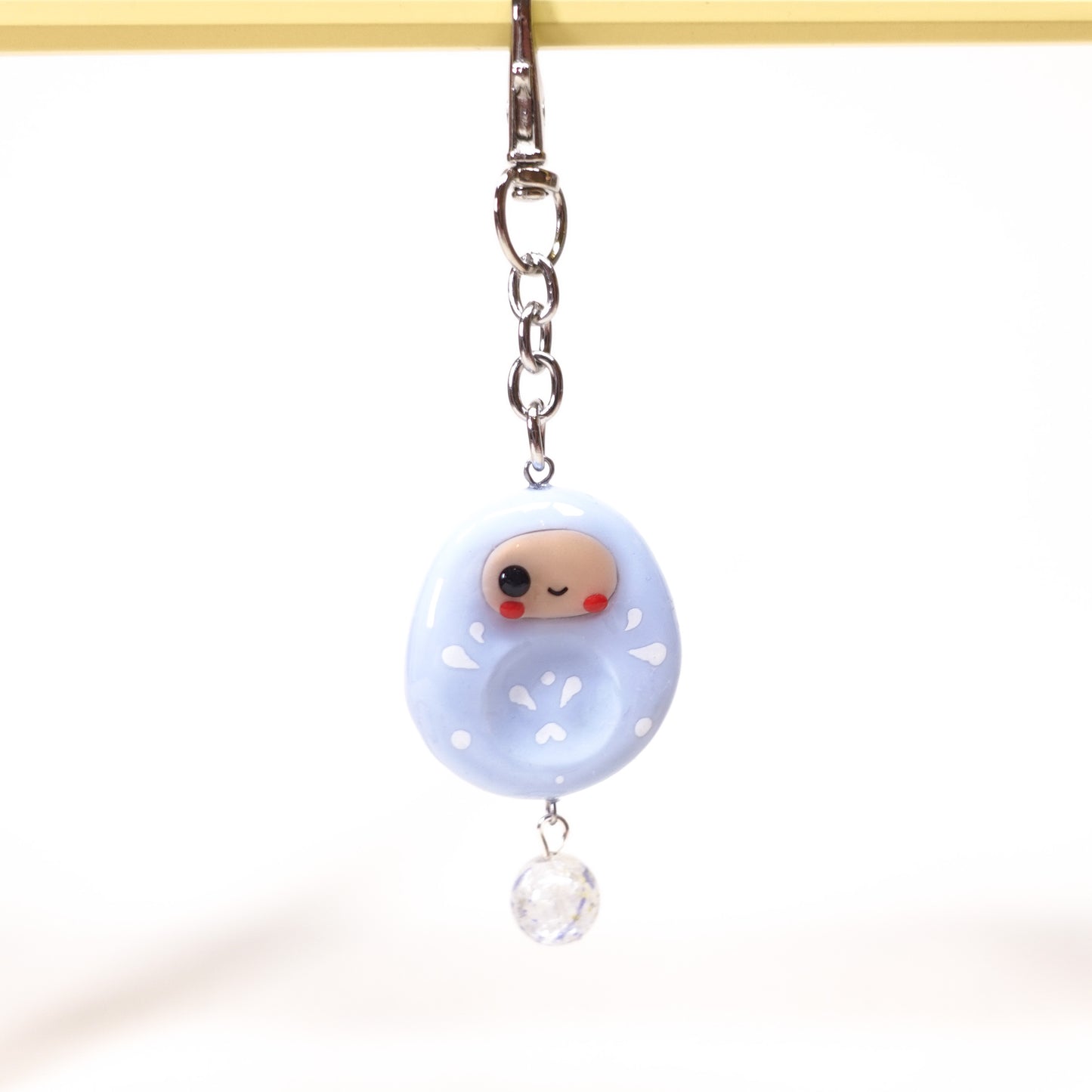 Japanese-inspired Daruma keychain with smooth worry stone texture
