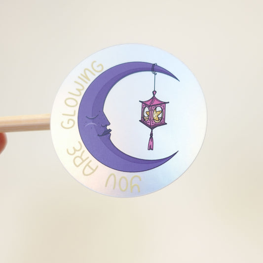 Cute motivational sticker with the text “You Are Glowing in Dark and Light”, featuring a cozy moon-inspired design from the Midnight Picnic collection. light
