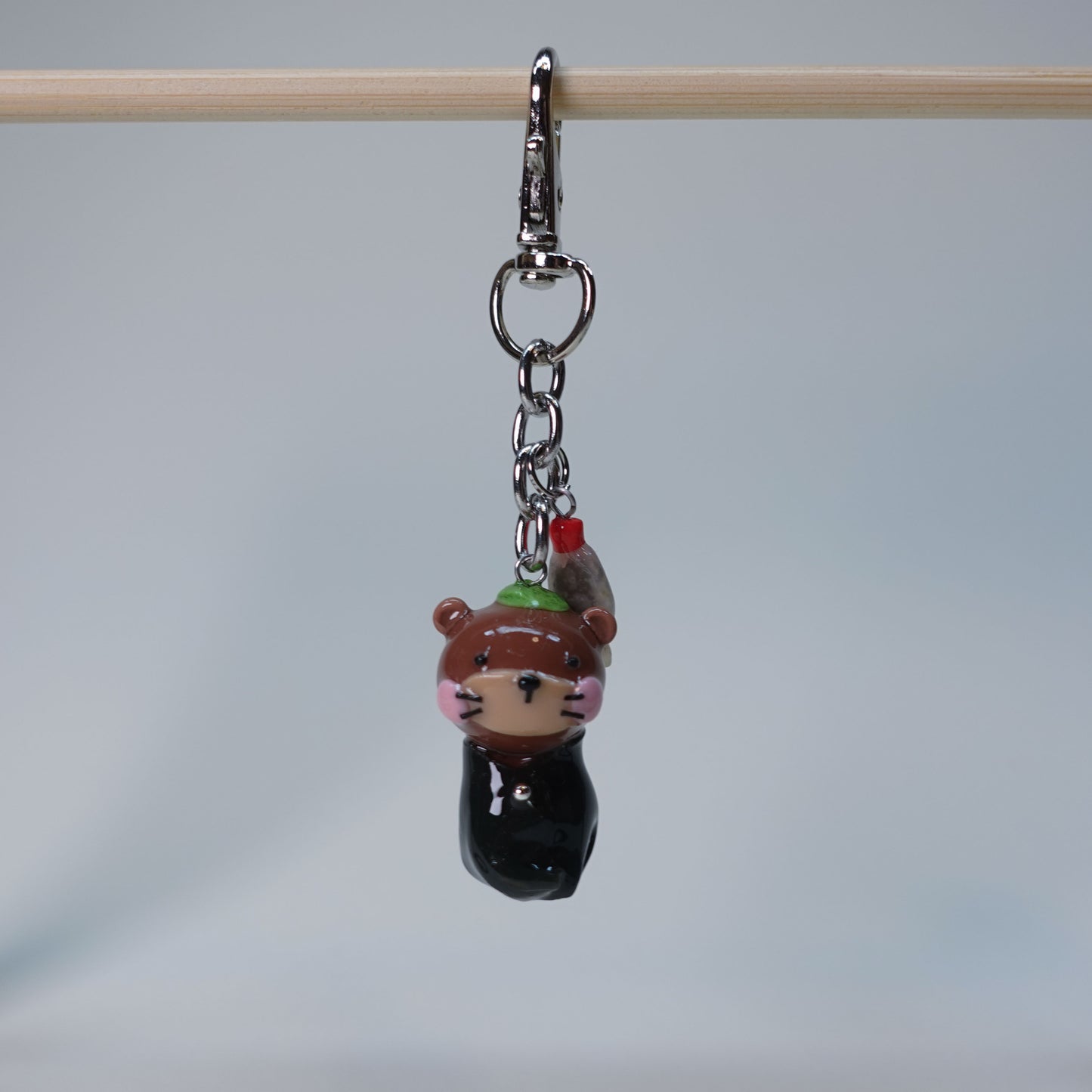 Handmade Sushi Otter keychain with extra soy fish charm, cute pastel accessory for bags or keys, limited edition collectible design.