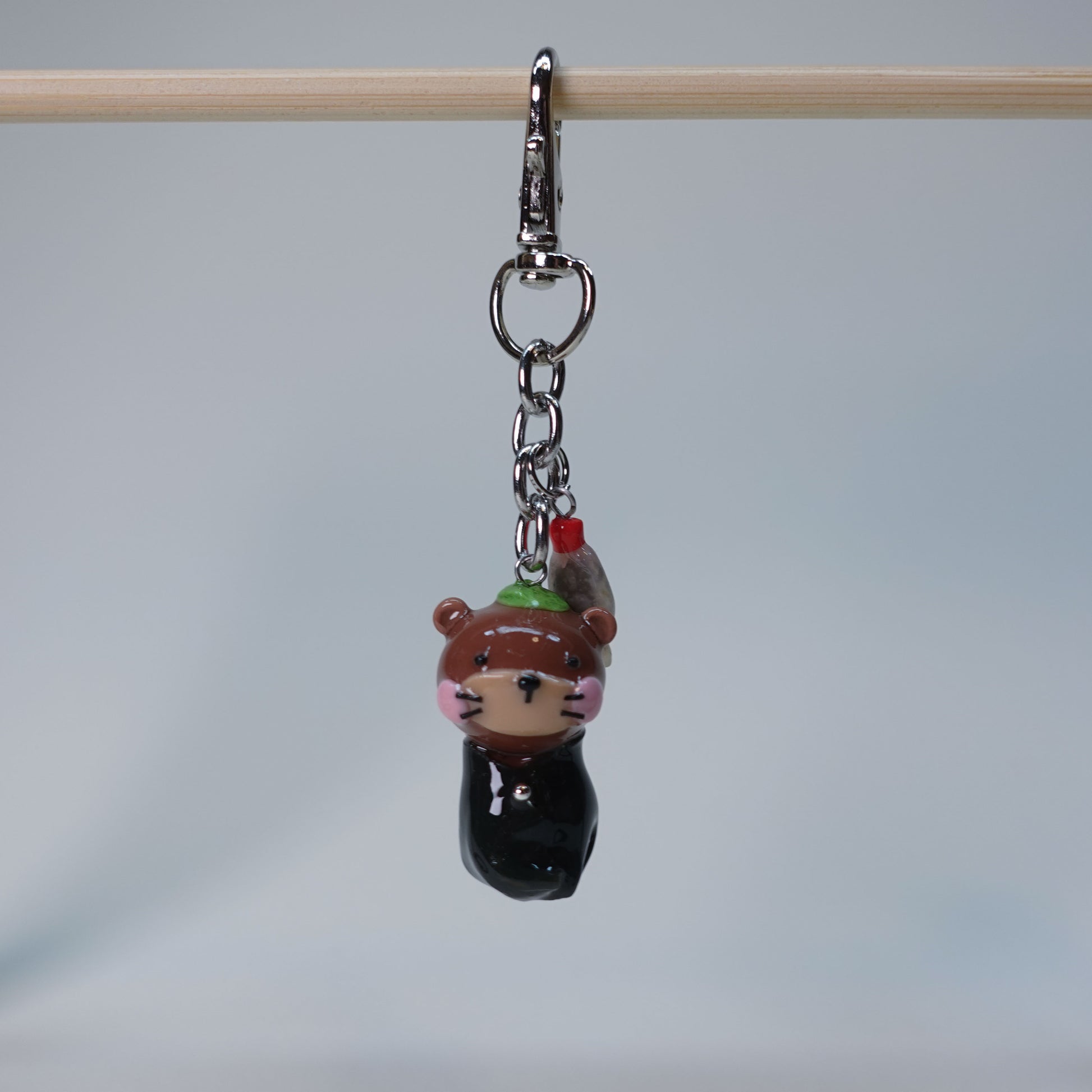 Handmade Sushi Otter keychain with extra soy fish charm, cute pastel accessory for bags or keys, limited edition collectible design.