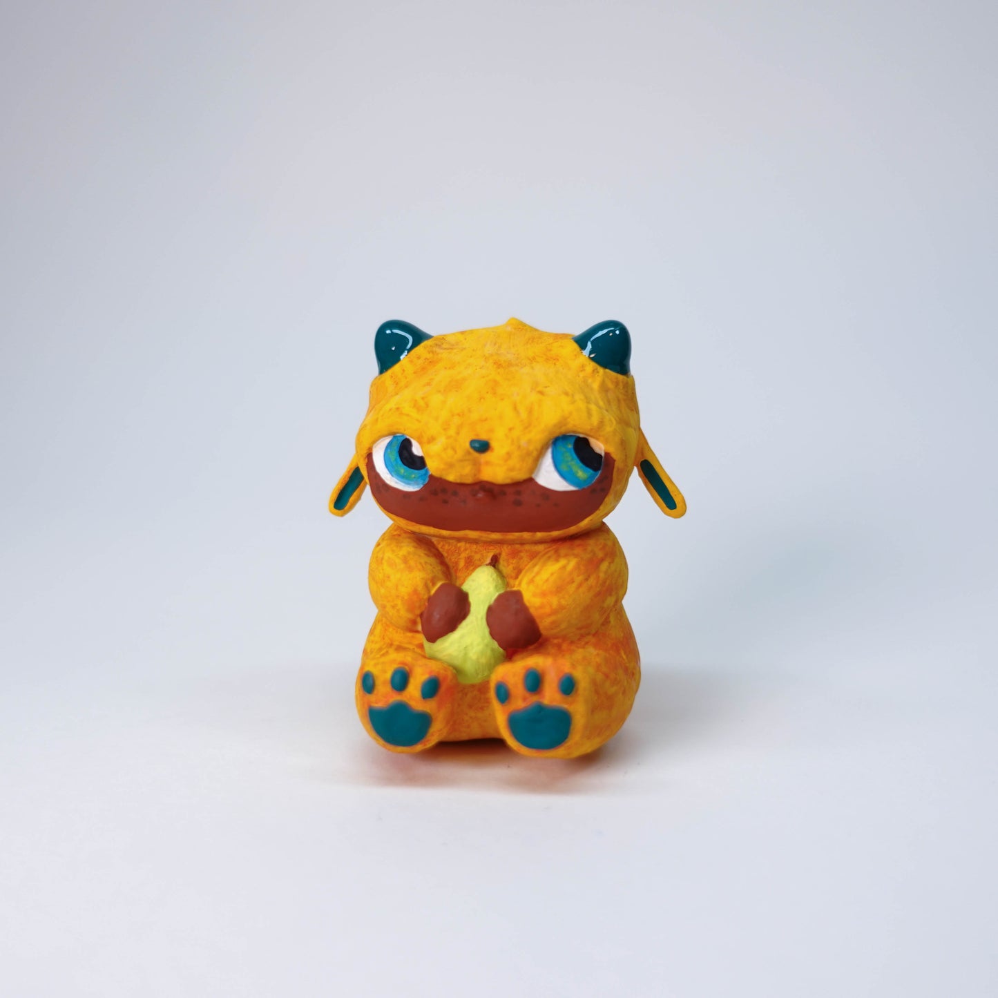 Hand-painted Pear Gremlin sculpture with orange fur, glossy horns, slight side-eye expression, 3D printed resin collectible figure, one-of-a-kind limited edition.