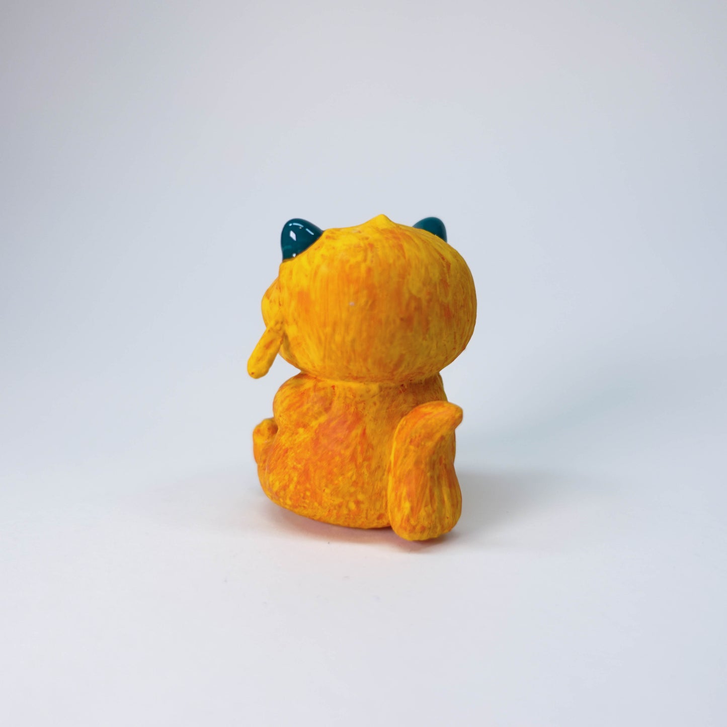 Pear Gremlin collectible resin sculpture with orange fur, glossy horns, slight side-eye, hand-painted matte finish, single limited edition piece.