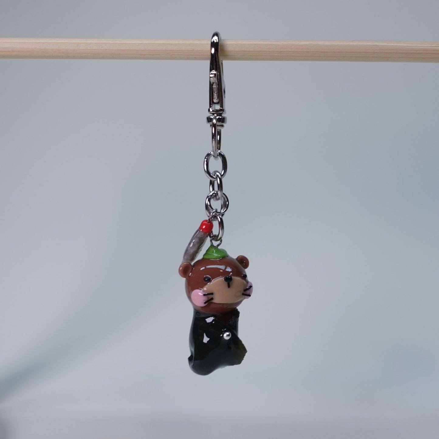 Handmade Sushi Otter keychain with extra soy fish charm, cute pastel accessory for bags or keys, limited edition collectible design.