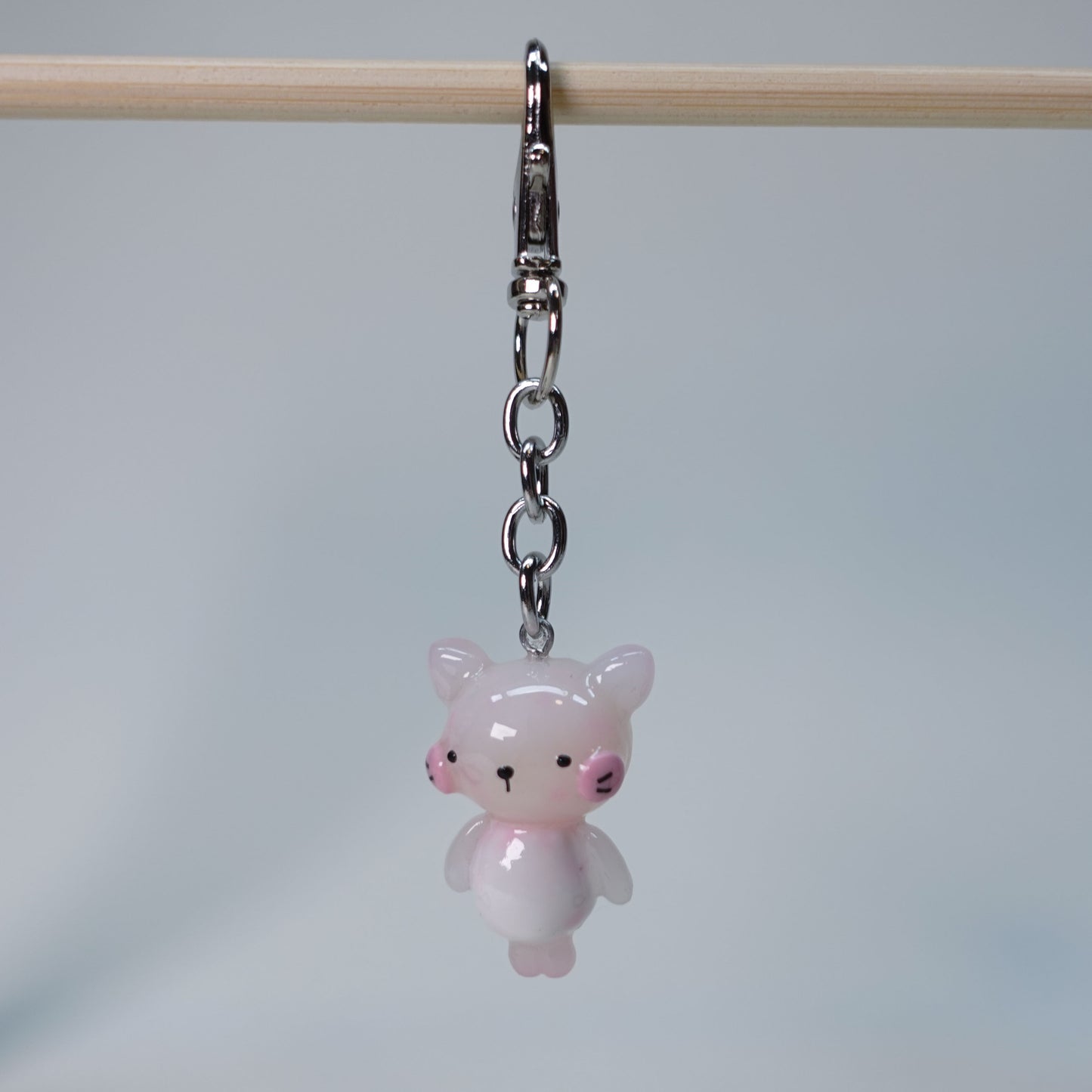 Light pink handmade pastel cat keychain with smooth glossy finish and simple cute design, small limited edition bag charm.