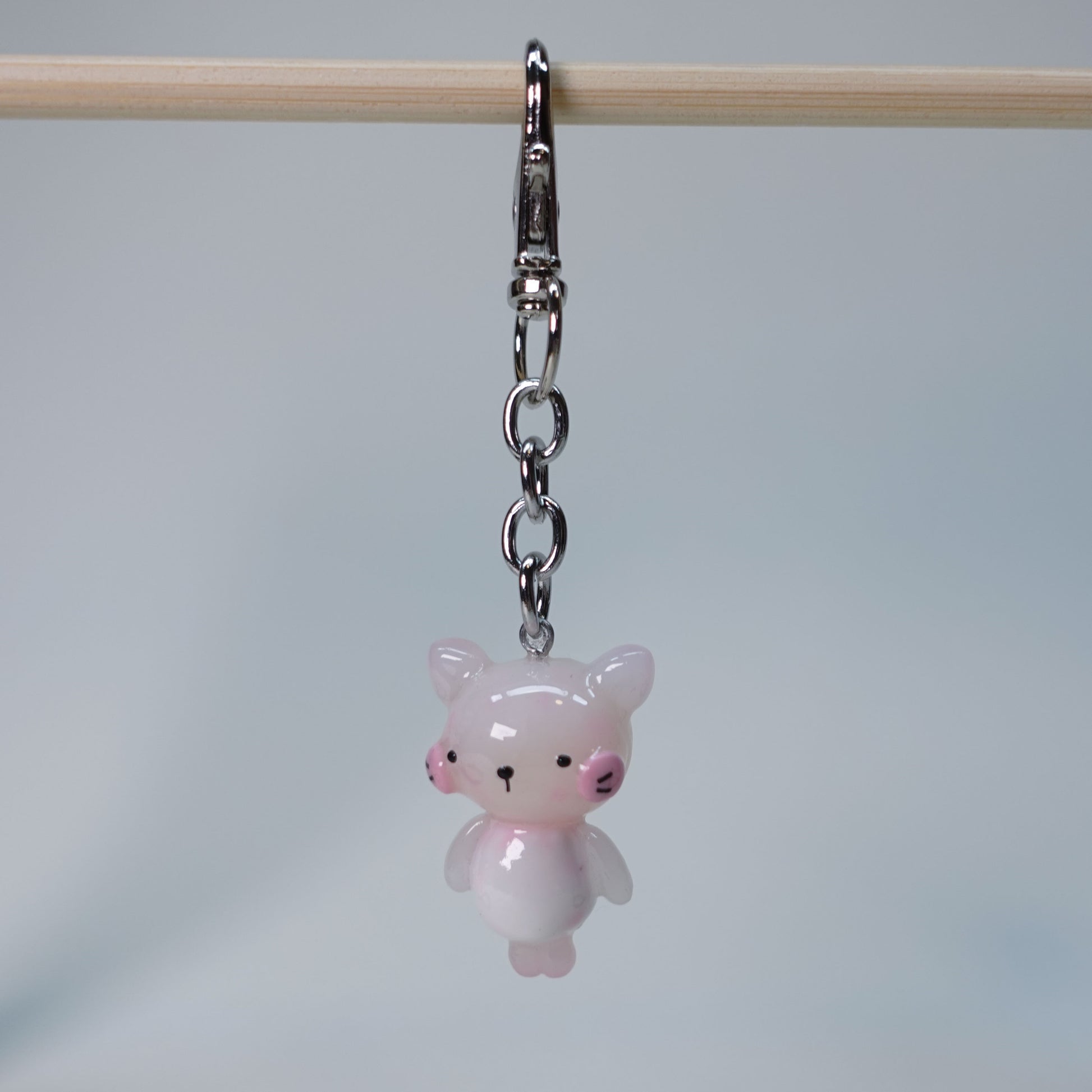 Light pink handmade pastel cat keychain with smooth glossy finish and simple cute design, small limited edition bag charm.