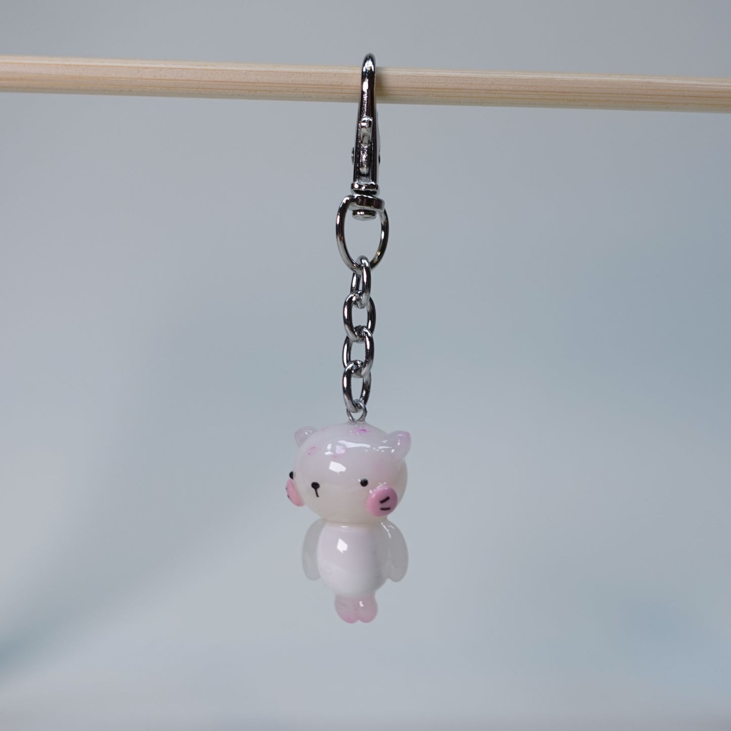 Light pink handmade pastel cat keychain with smooth glossy finish and simple cute design, small limited edition bag charm.